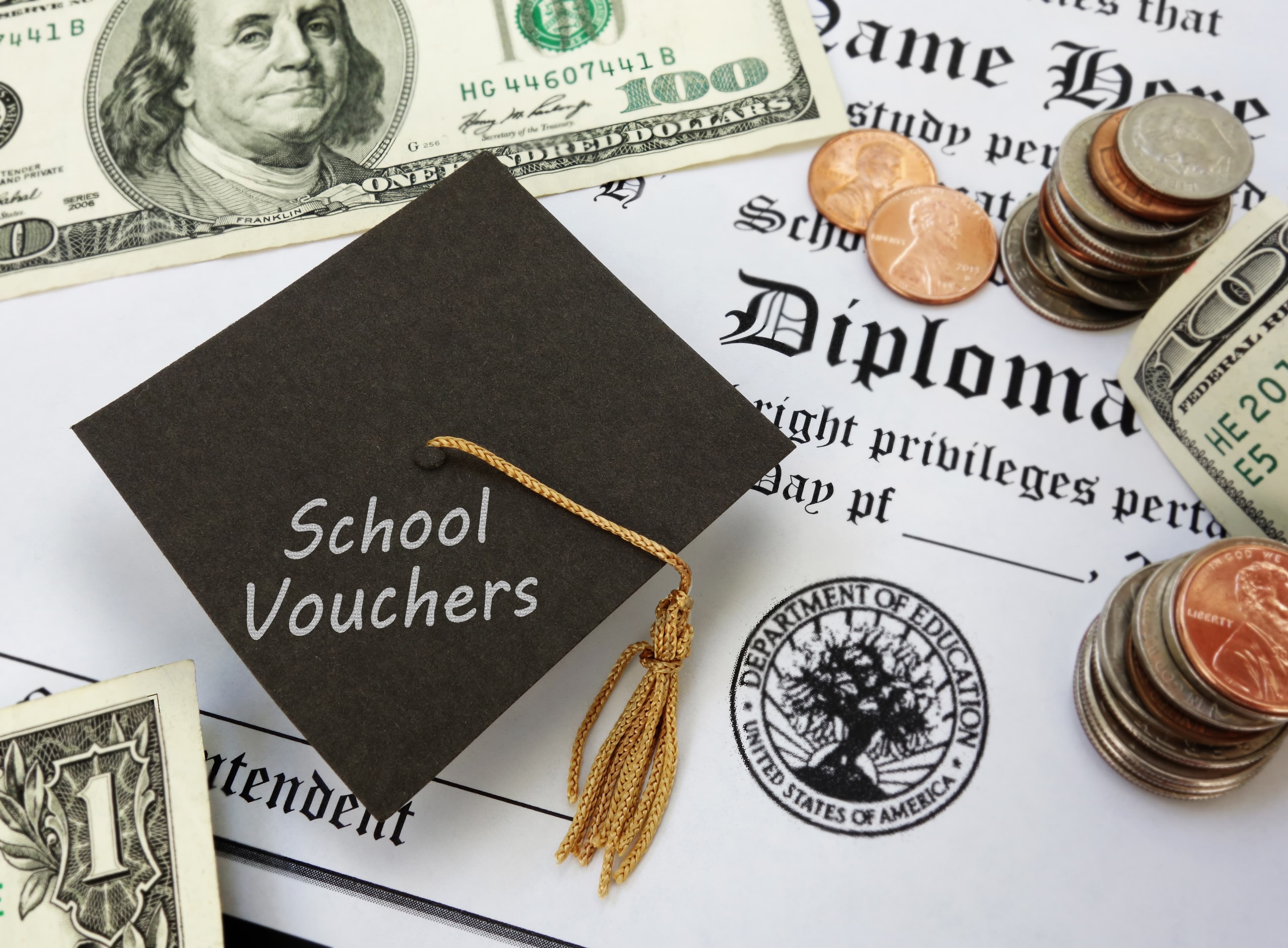 High school diploma with School Vouchers text on a graduation cap