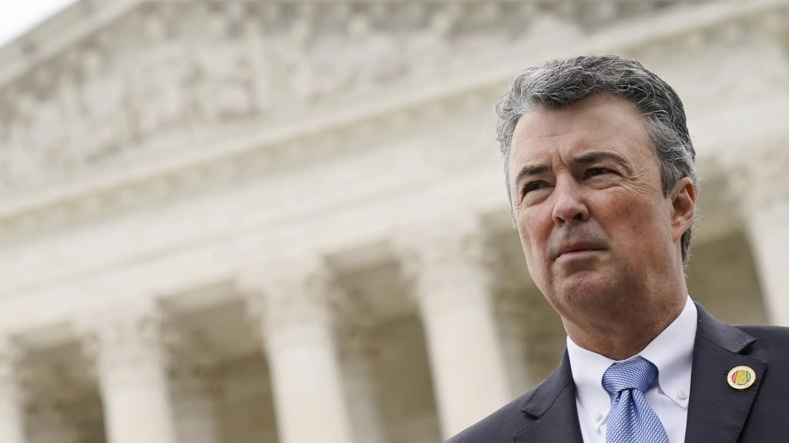 Alabama Attorney General Steve Marshall listens to a reporter's question following oral arguments in Merrill v. Milligan, an Alabama redistricting case that could have far-reaching effects on minority voting power across the United States, outside the Supreme Court on Capitol Hill in Washington, Tuesday, Oct. 4, 2022.