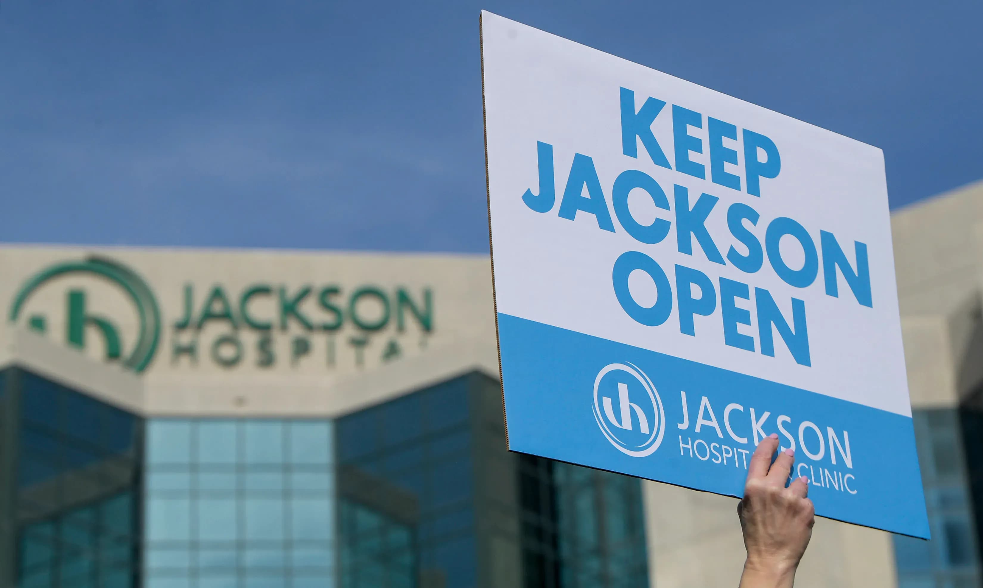 Employees hold signs at a rally and press conference on Thursday, Jan. 30, 2025 to ask the City of Montgomery for a guarantee on a loan to keep Jackson Hospital open.