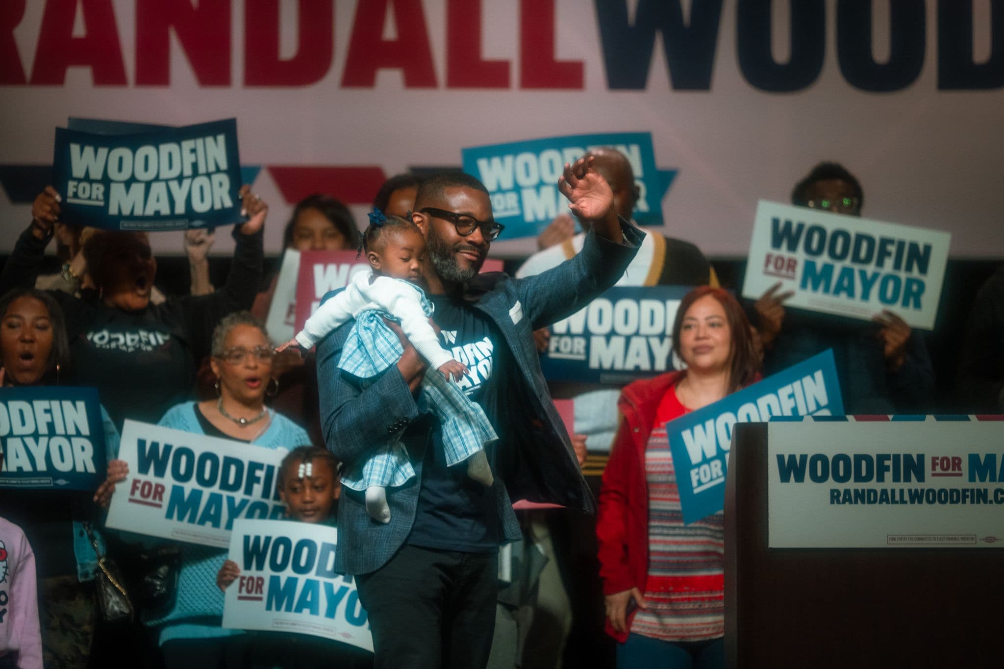 Holding his daughter Love, Mayor Woodfin reflected on his administration’s accomplishments and ongoing efforts to expand infrastructure, public safety and education investments