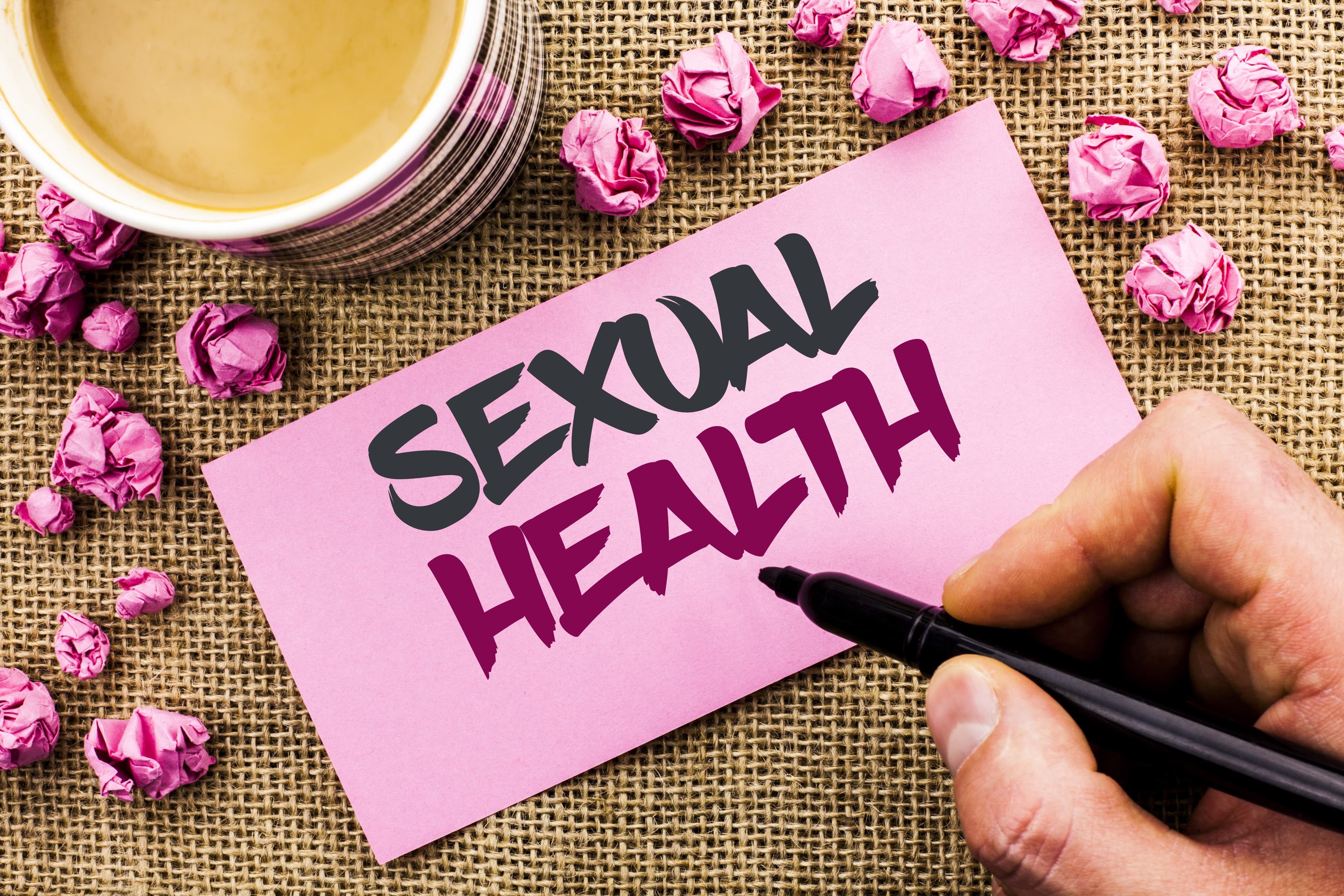 Conceptual hand writing showing Sexual Health. Business photo text STD prevention Use Protection Healthy Habits Sex Care written by Man Holding Marker Paper the jute background Cup