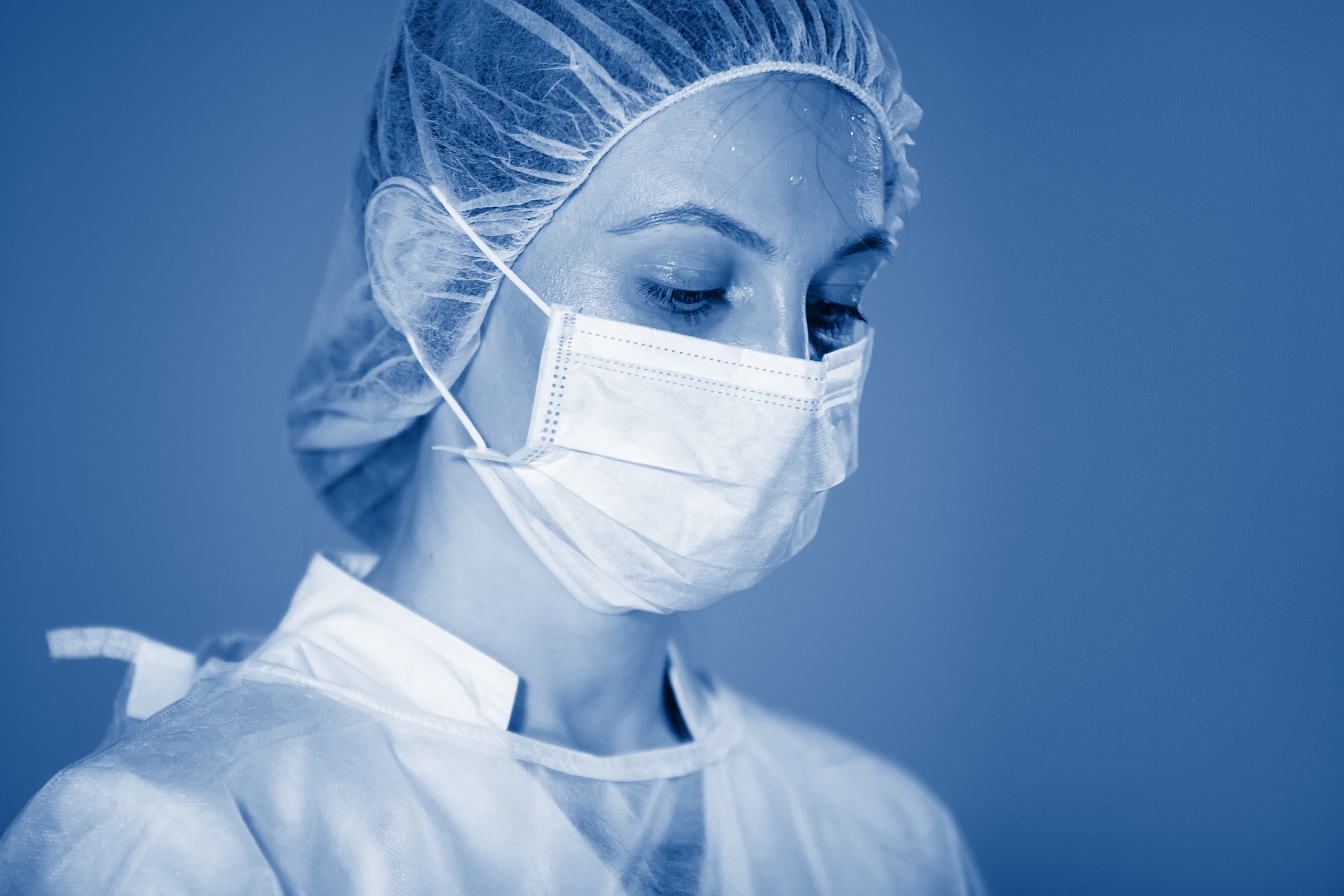 Nurse in a cap and mask during surgery