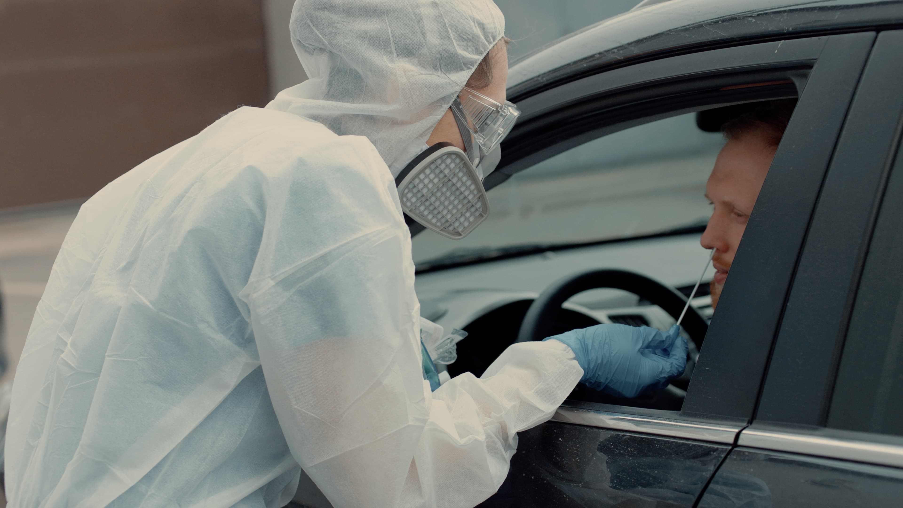 Patient is being tested in his vehicle on a drive-through coronavirus COVID-19 testing location. Pandemic, infection