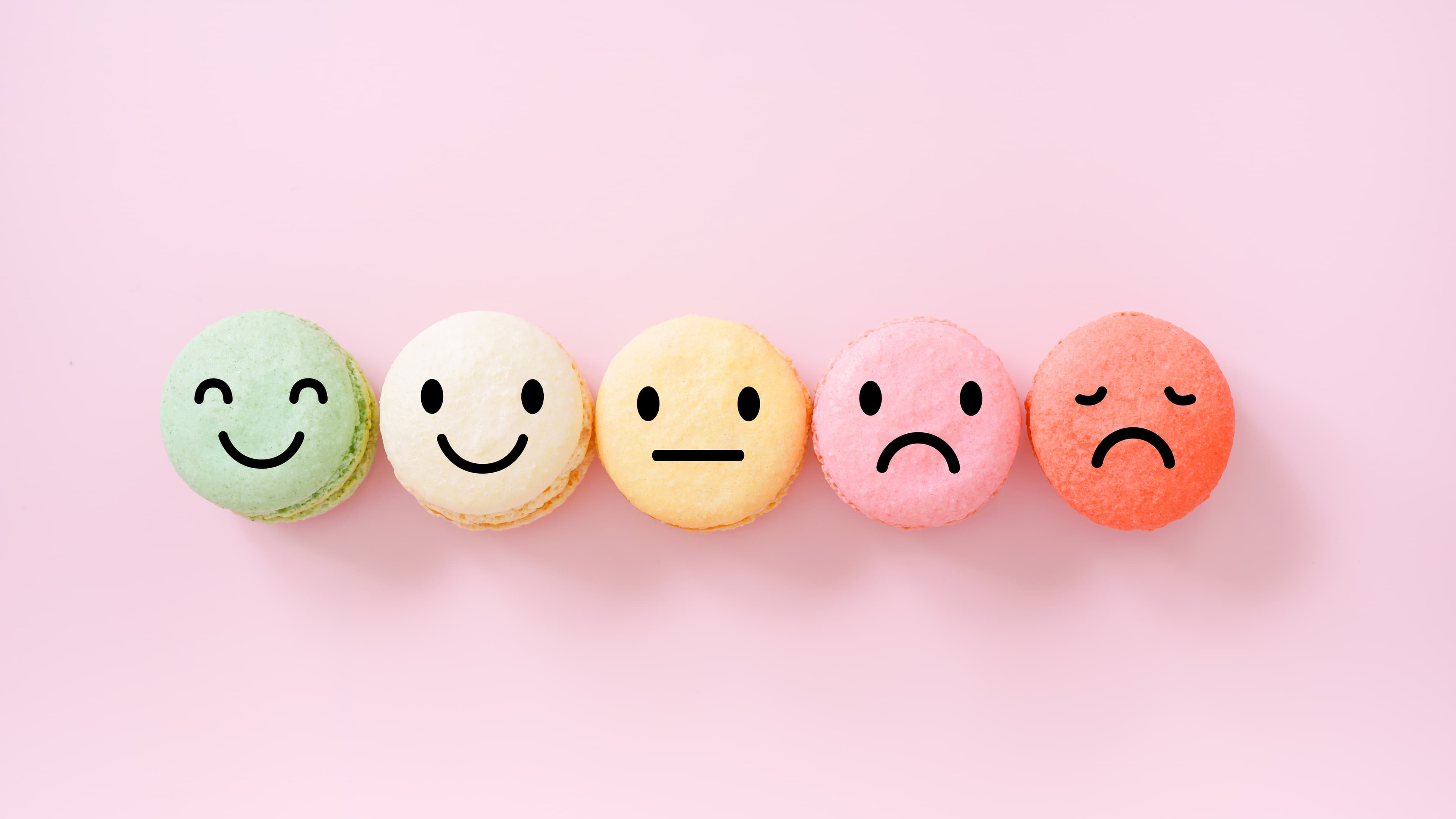 emotion face on multi colored macarons , good feedback rating and positive customer review, experience, satisfaction survey ,mental health assessment, child wellness, world mental health concept