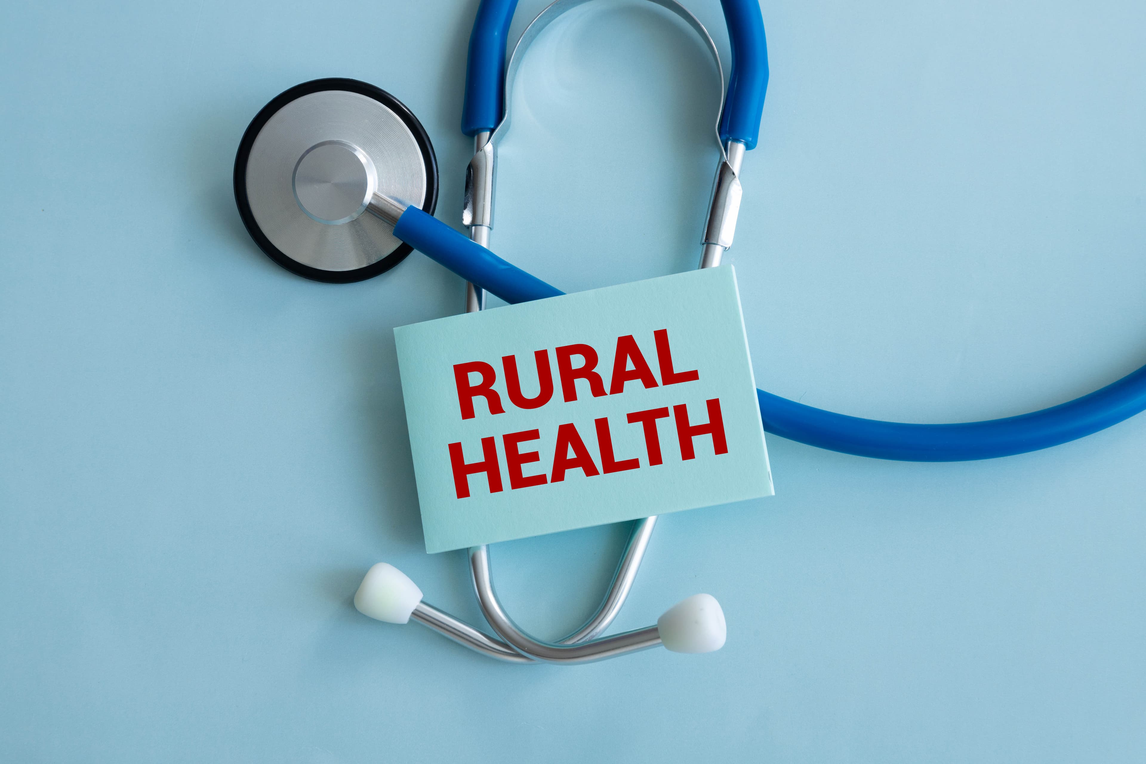 Doctor holding a card with text rural health,medical concept