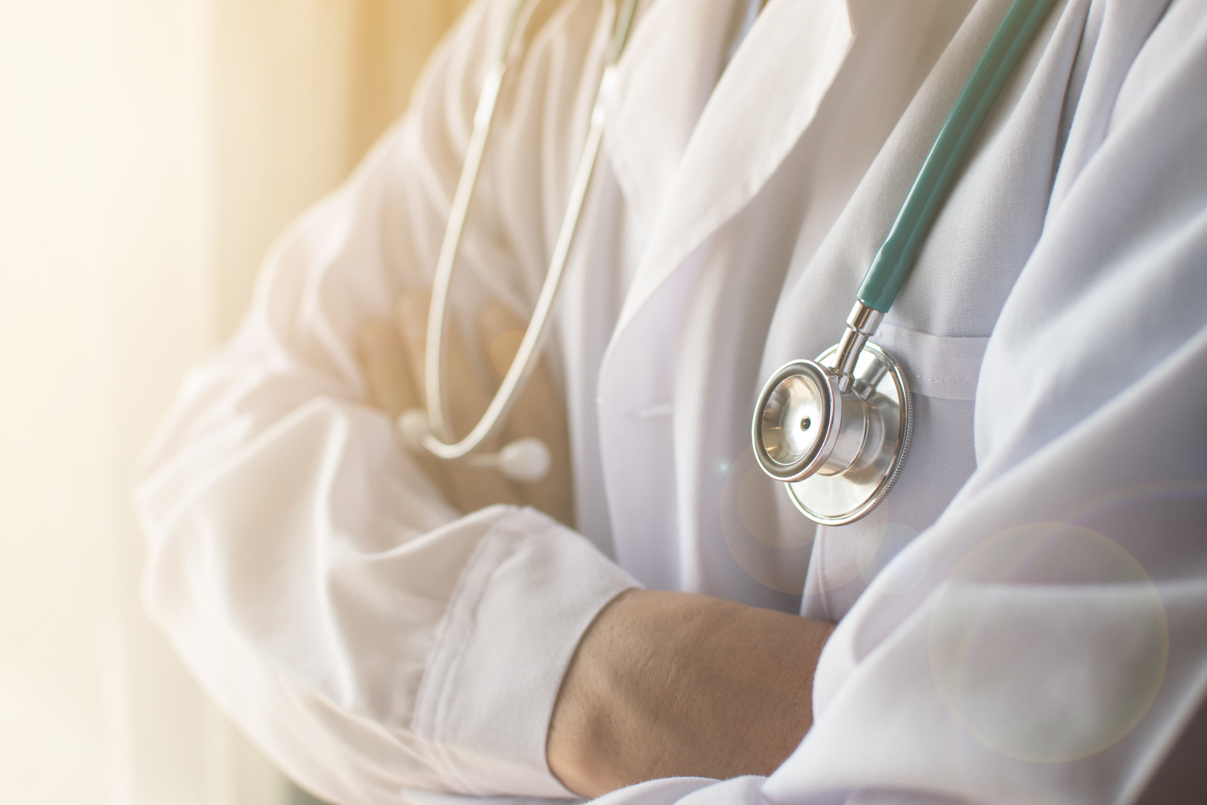 Medical doctor or physician staff in white gown uniform with ste