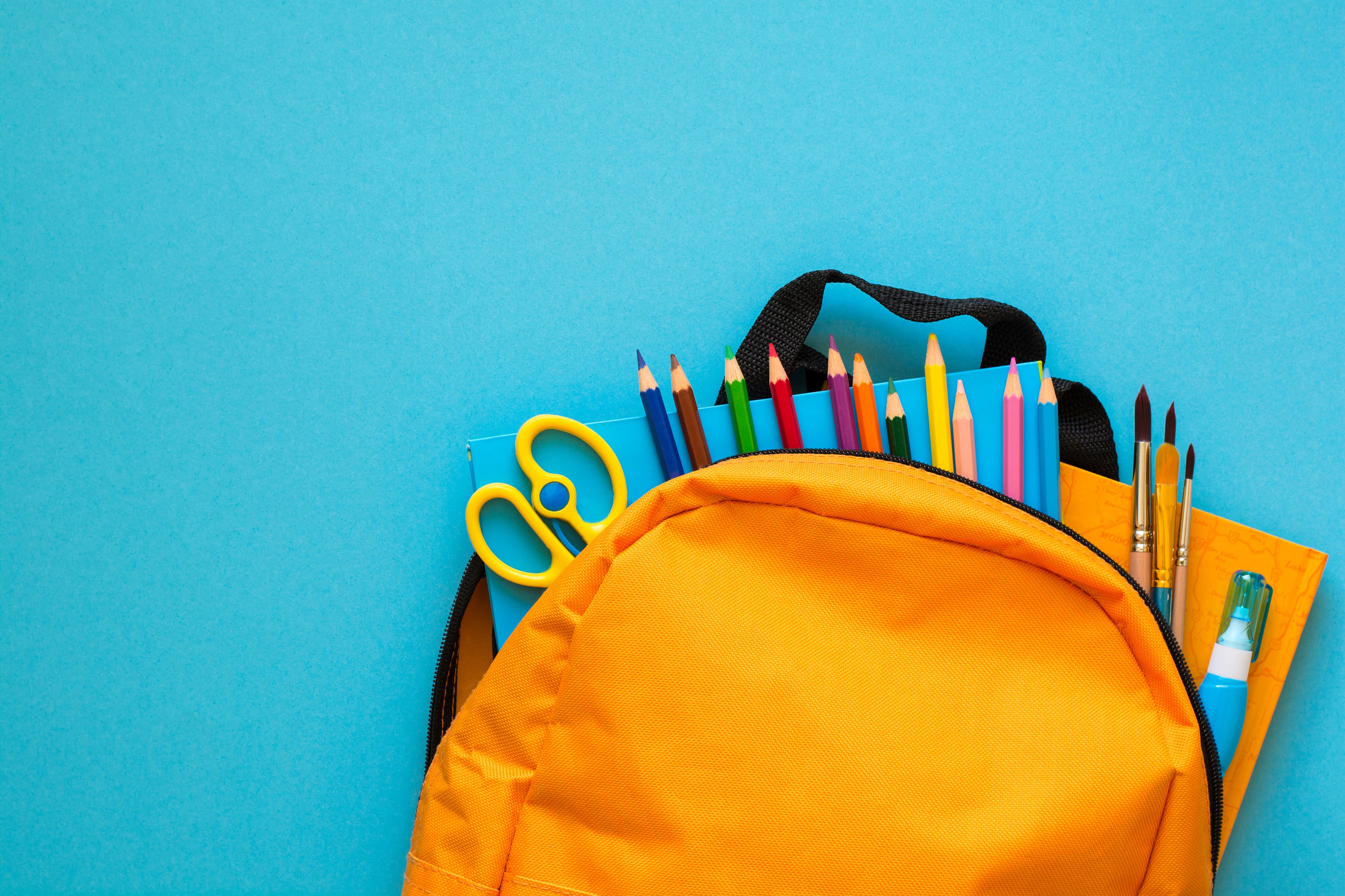 Back to shcool concept. Backpack with school supplies. Top view. Copy space
