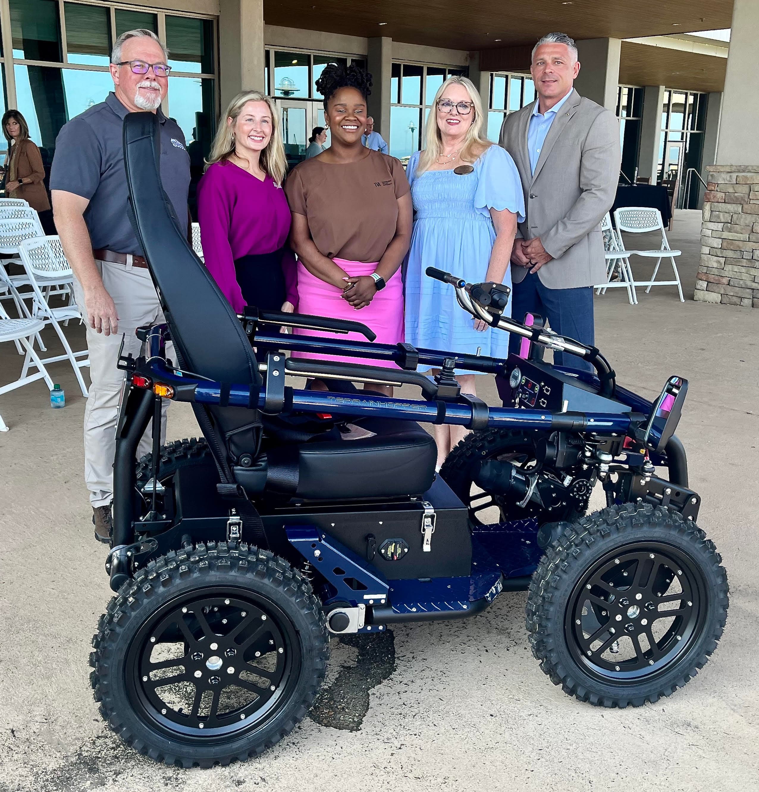 Officials pose with the new specialized all-terrain mobility vehicle at Lake Guntersville State Park on Tuesday, Aug. 11, 2026. The officials, from left, are Lake Guntersville State Park Superintendent Heath Puckett, Lauren Pelto and Tori Chatman from TVA, Alabama Mountain Lakes Tourist Association President/CEO Tami Reist and Alabama State Parks Deputy Director Chad Davis.