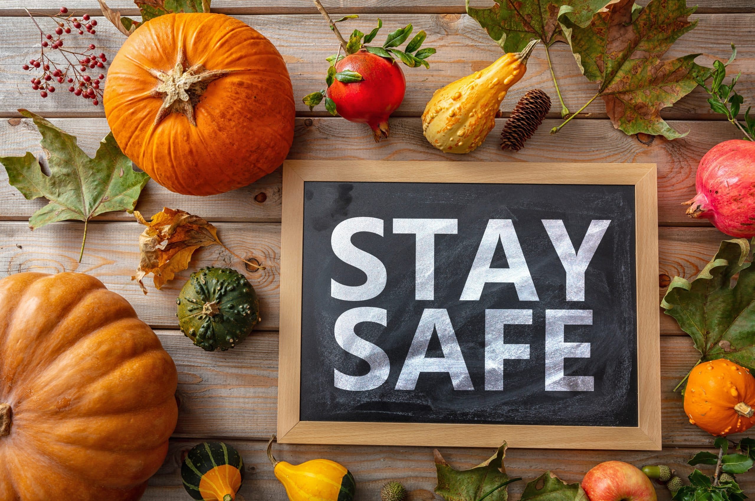 Thanksgiving COVID 19 days. STAY SAFE message and thanksgiving flatlay on wooden background. Coronavirus protection