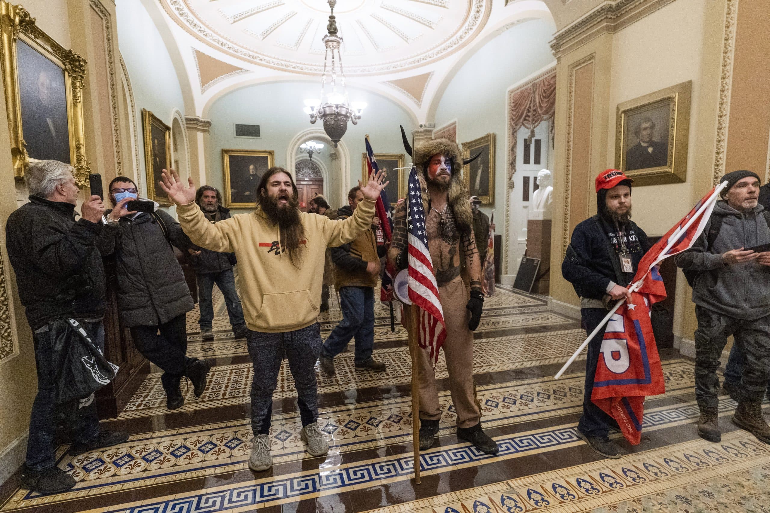 Supporters of President Donald Trump are confronted by U.S. Capitol Police officers outside the Senate Chamber inside the Capitol, Wednesday, Jan. 6, 2021 in Washington. (AP PHOTO/MANUEL BALCE CENETA)