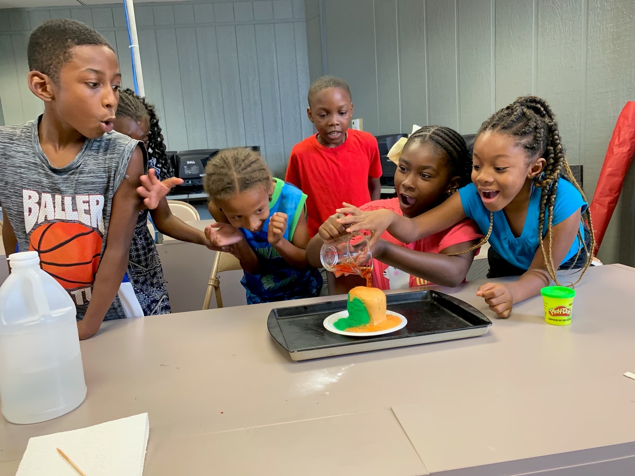 Third graders participate in making a volcano at a SAIL summer program.
