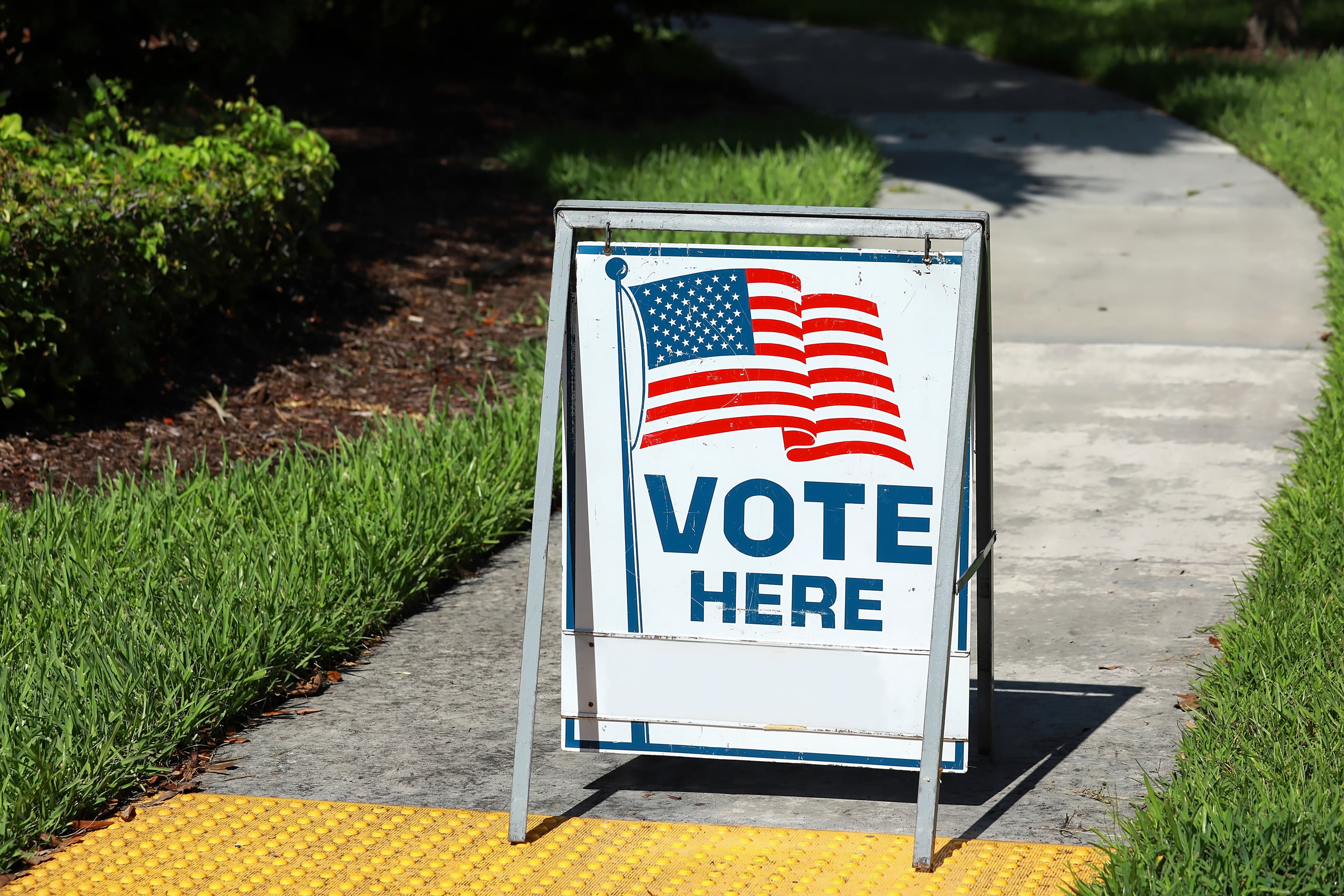 VOTE HERE SIGN placed on the walkway to a neighborhood polling place, as seen on election day in Fort Lauderdale, Florida, USA.