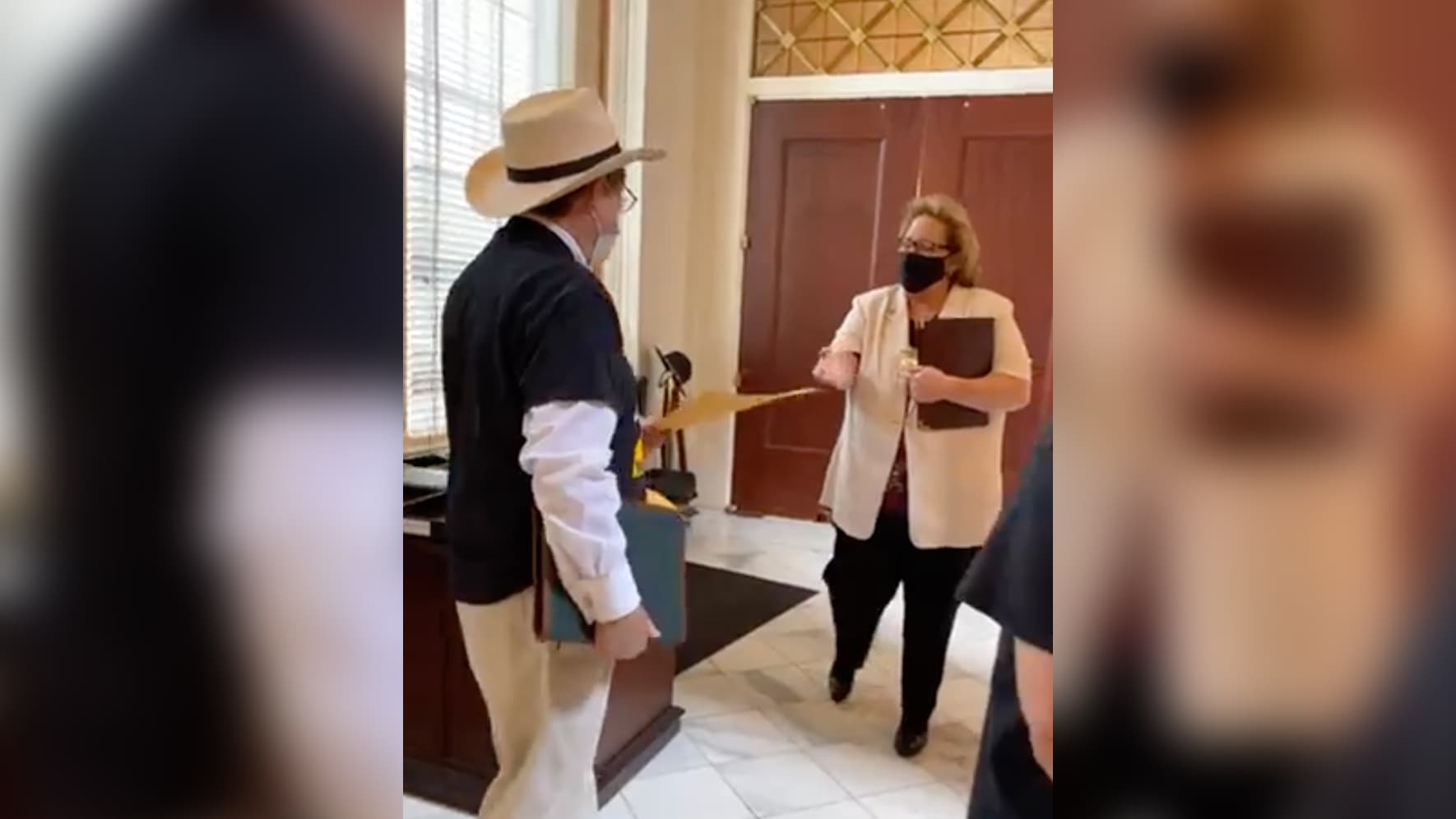 Rev. Tonny Algood, of the United Methodist Inner City Mission, presents the Poor People's Campaign list of legislative priorities to an Alabama State House official. Credit: Facebook