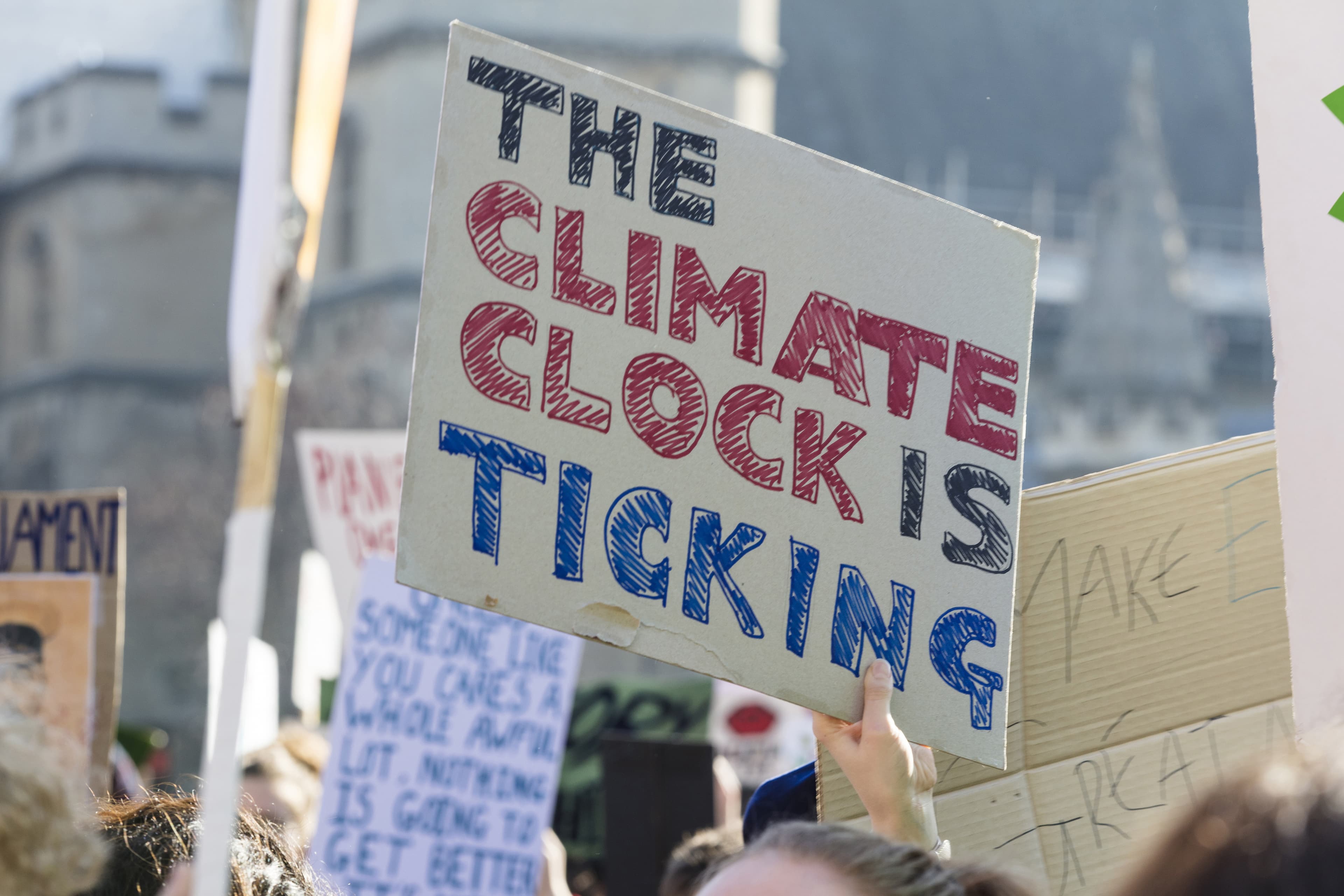 Protestors holding climate change banners at a protest