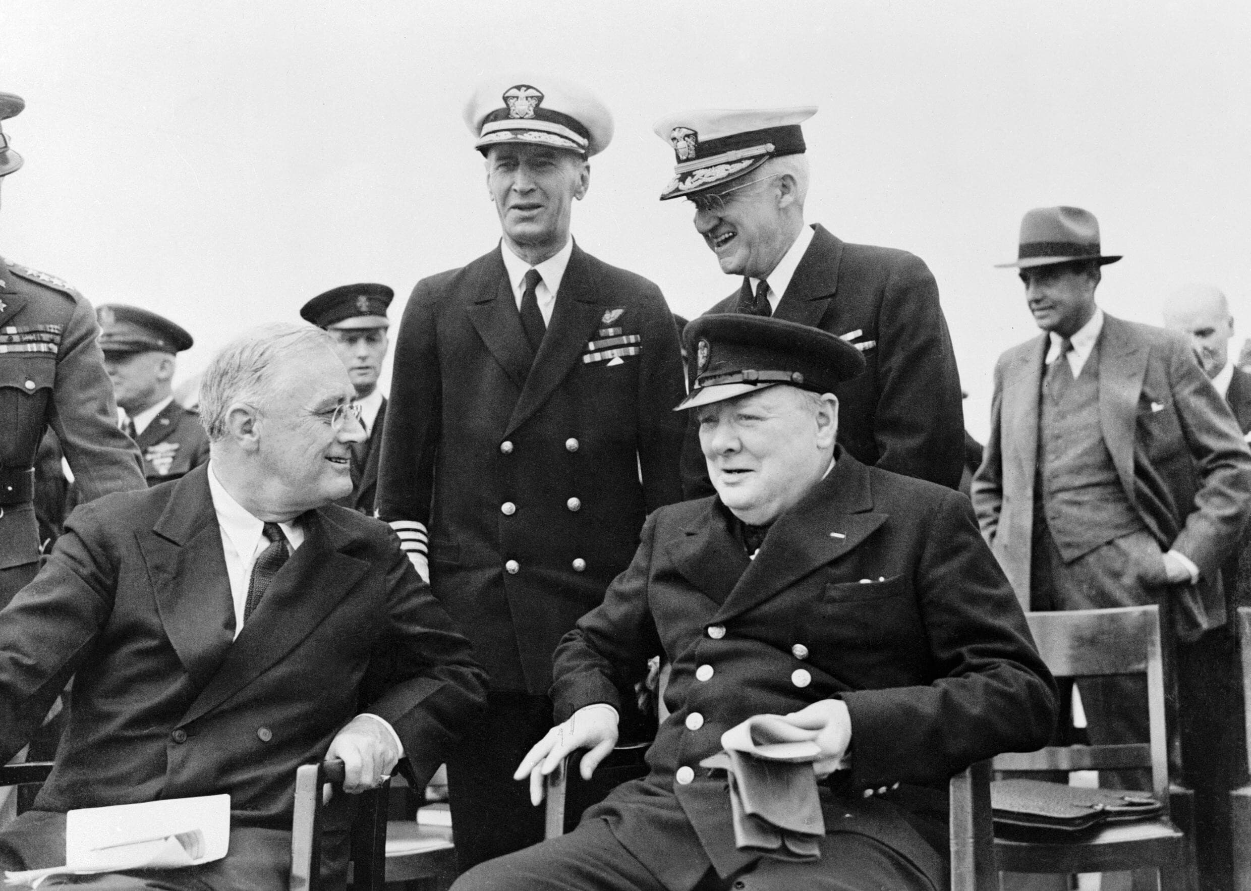 President Roosevelt and Winston Churchill seated on the quarterdeck of HMS PRINCE OF WALES for a Sunday service during the Atlantic Conference, Aug. 10, 1941.