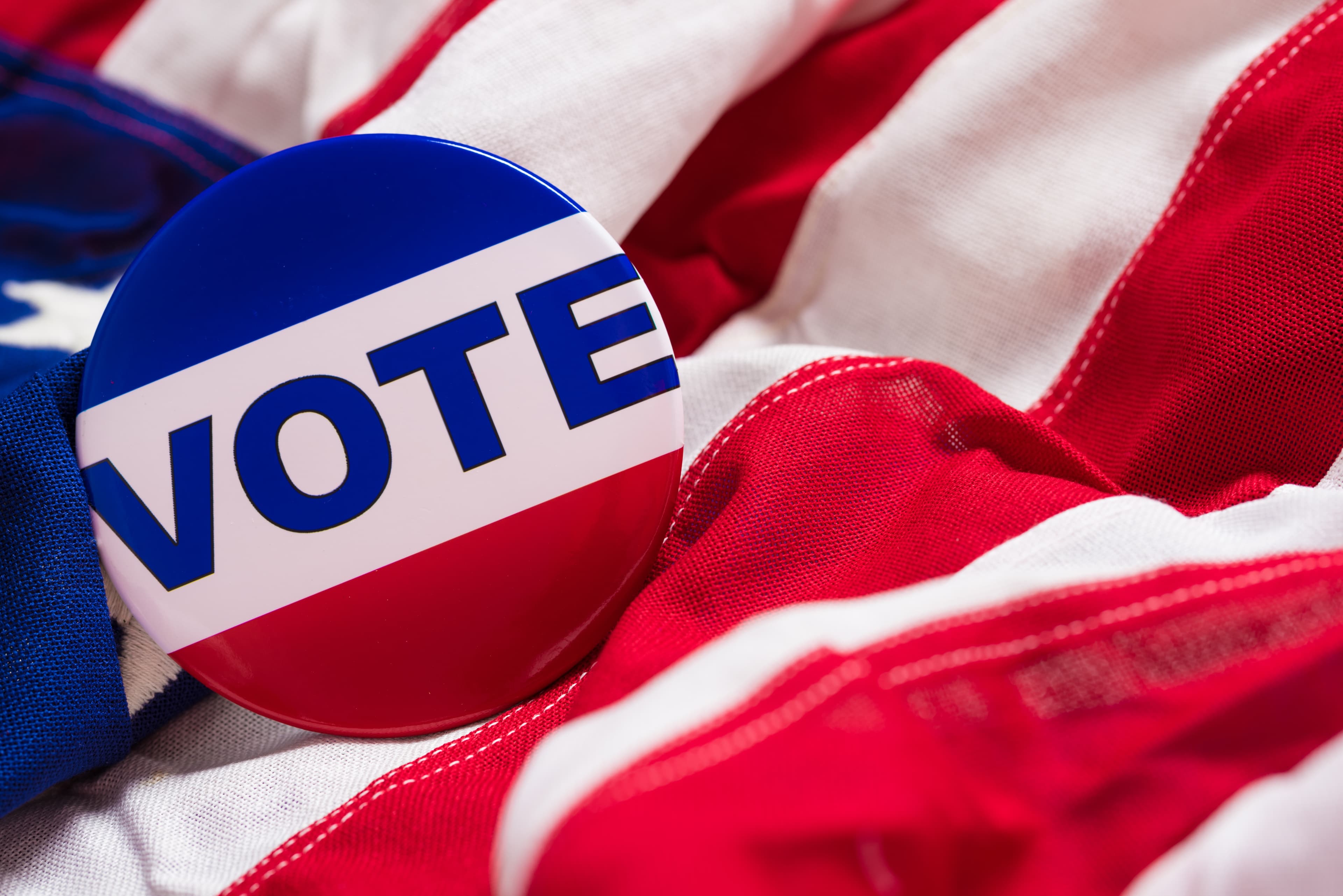 "VOTE" button or pin on an American flag
