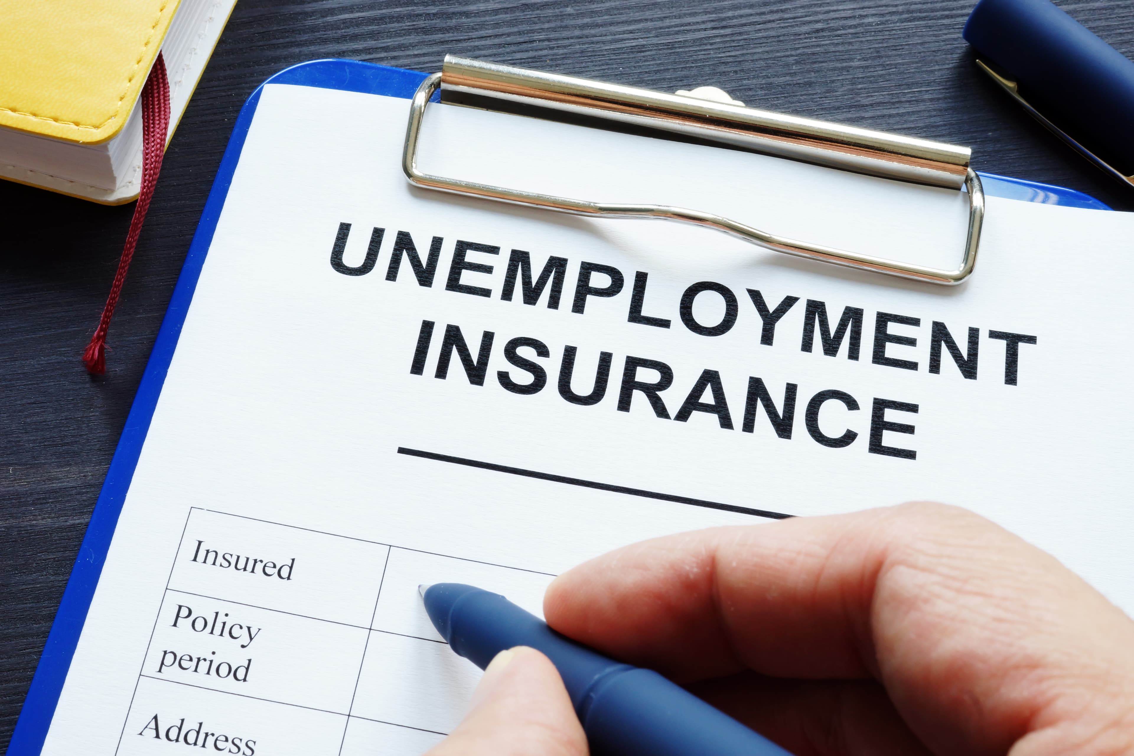 Man is filling in unemployment insurance in the office.