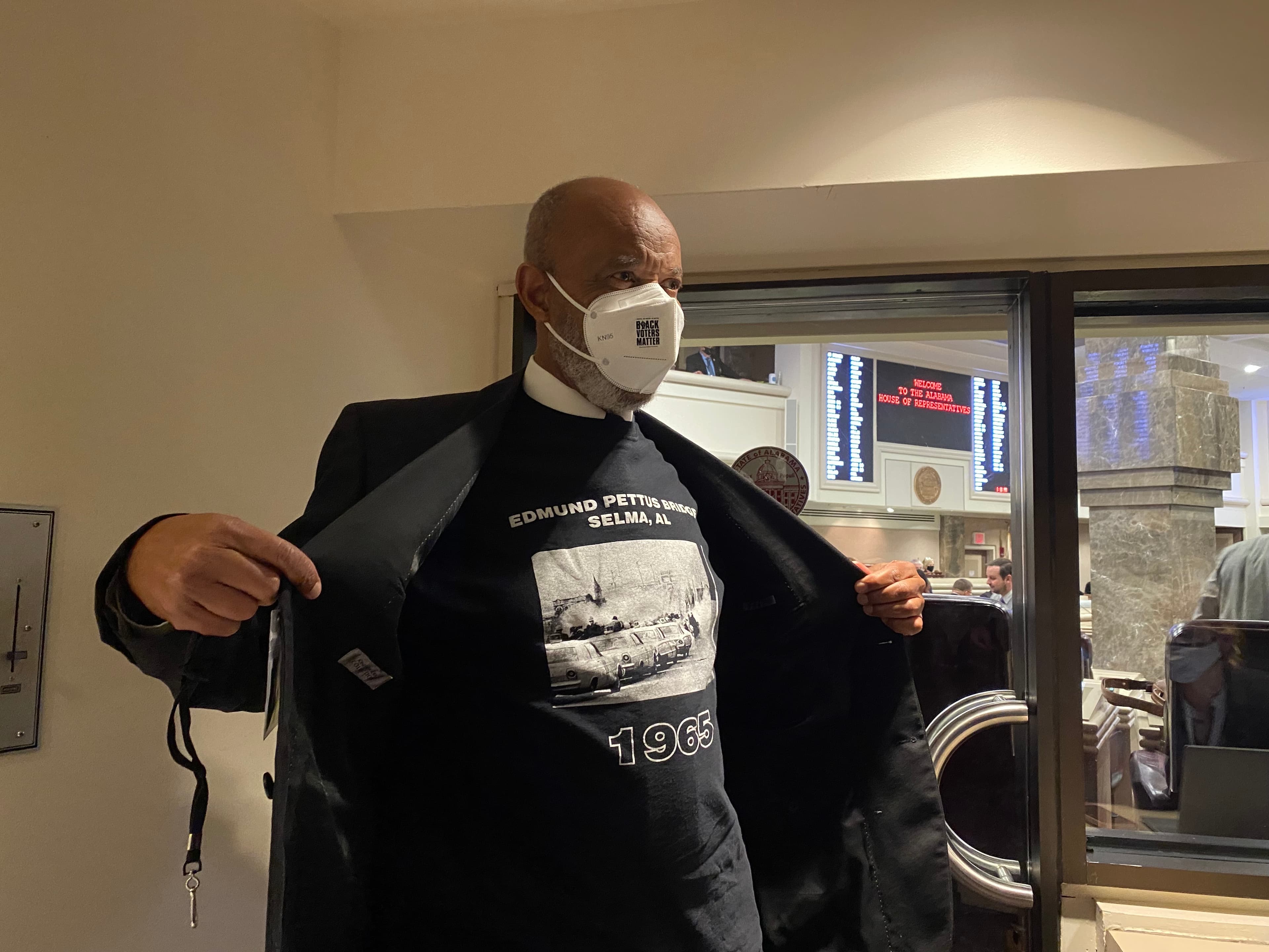 Rep. A.J. McCampbell, D-Gallion, shows reporters his shirt depicting the Bloody Sunday march in Selma in 1965. McCampbell drew connections to the anti-riot bill passed by the House Tuesday. (Jacob Holmes / APR)