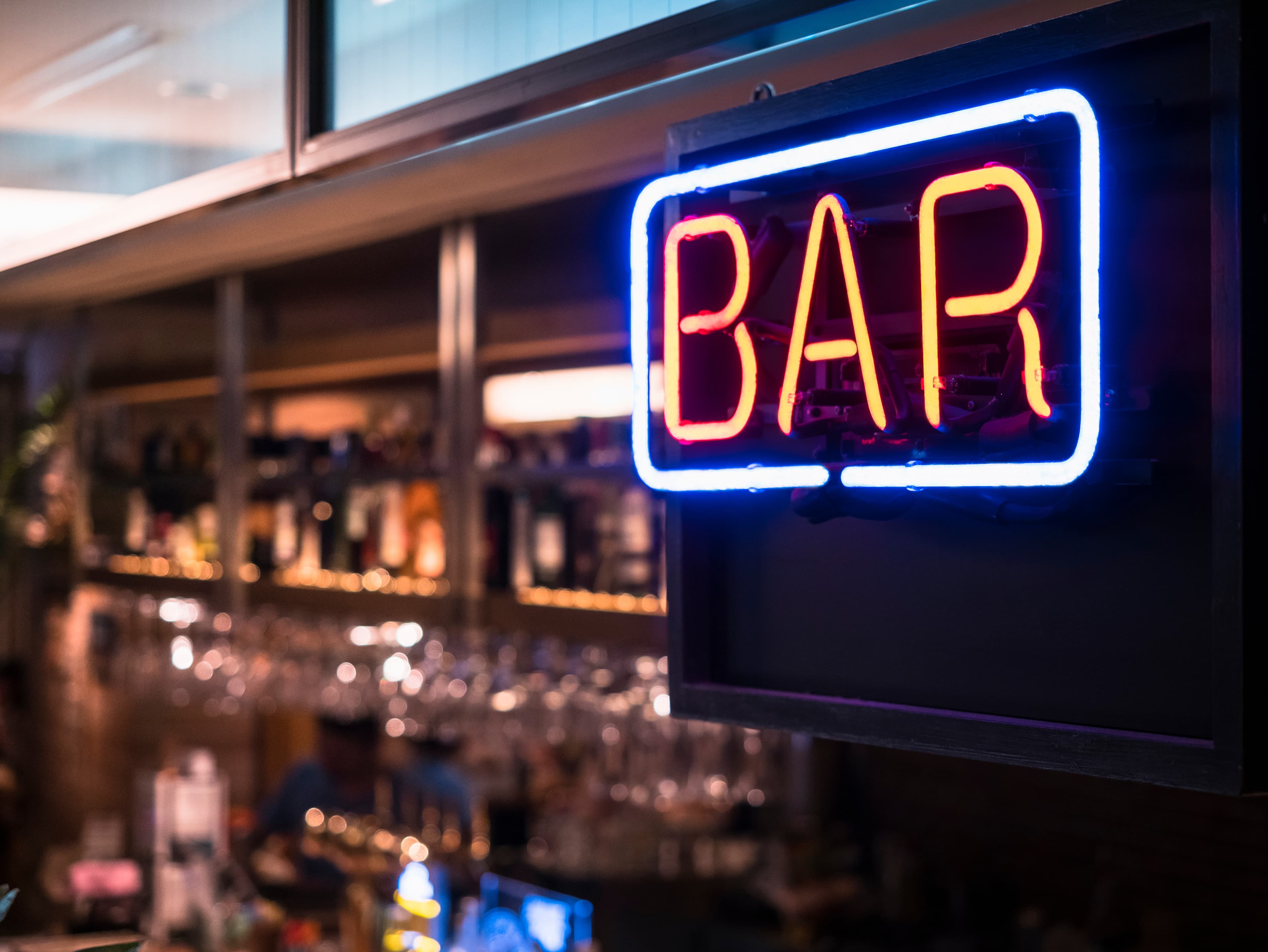 Bar signage Lights neon sign Blur bar counter shelf bottles back