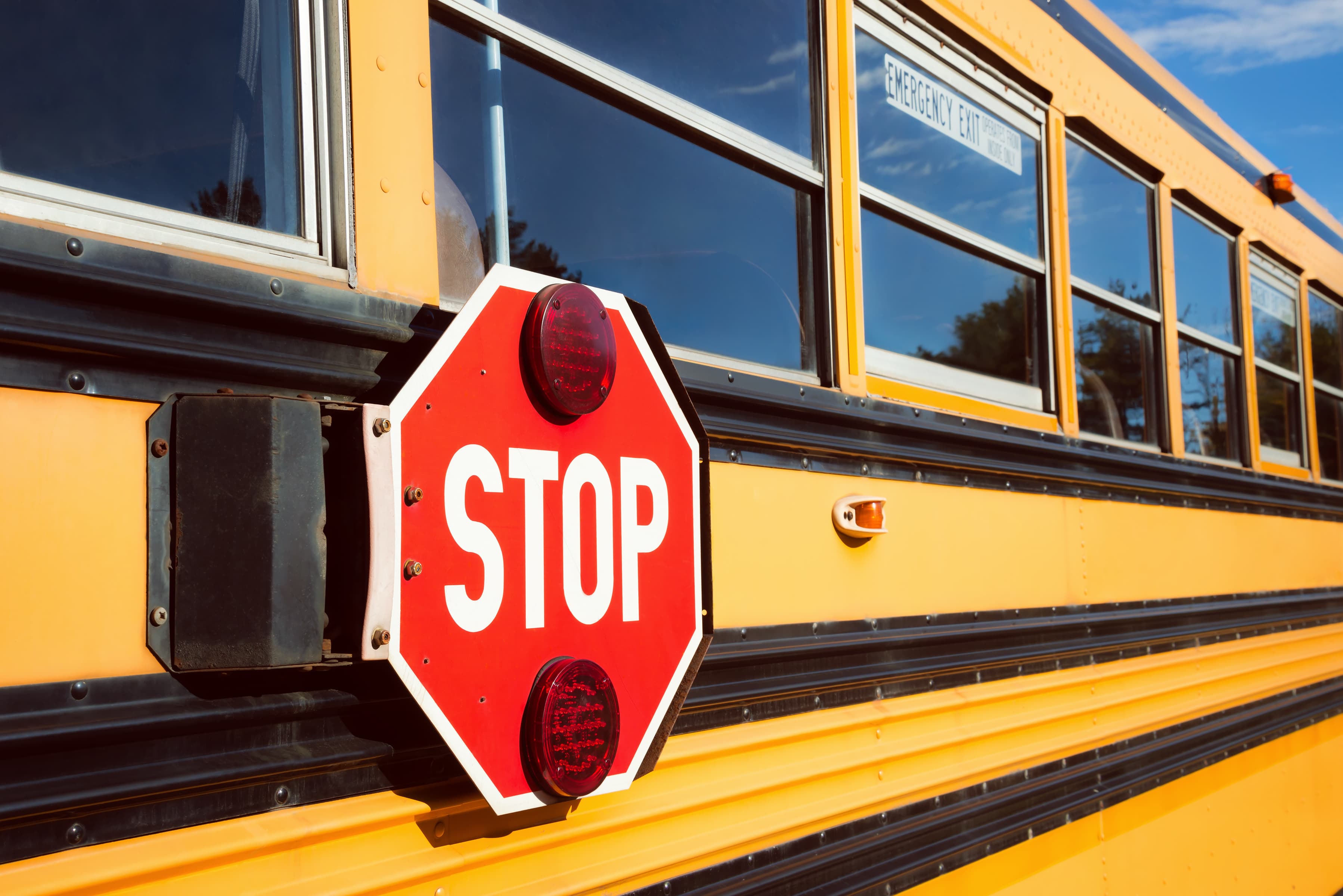 Stop sign on yellow school bus