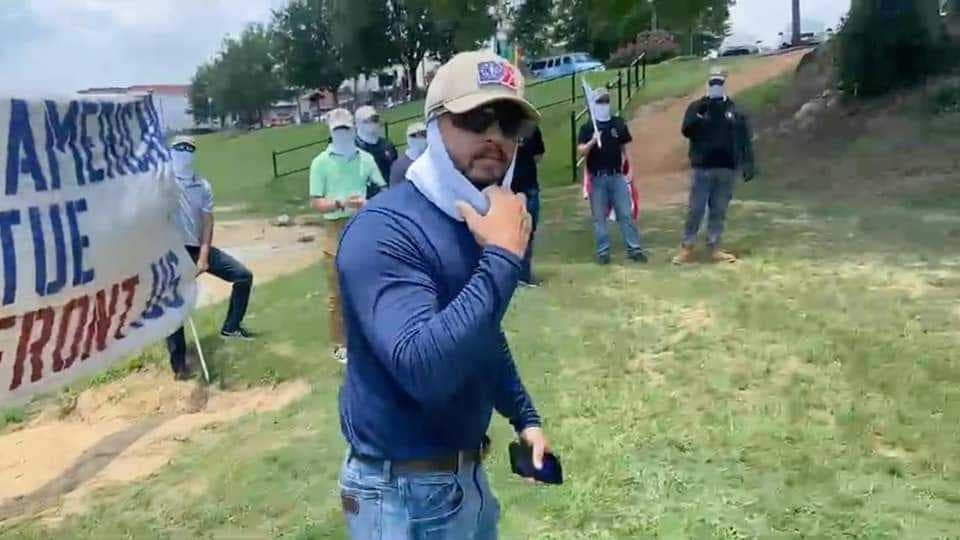 A member of Patriot Front briefly unmasked during a protest at a Prattville pride picnic Saturday.