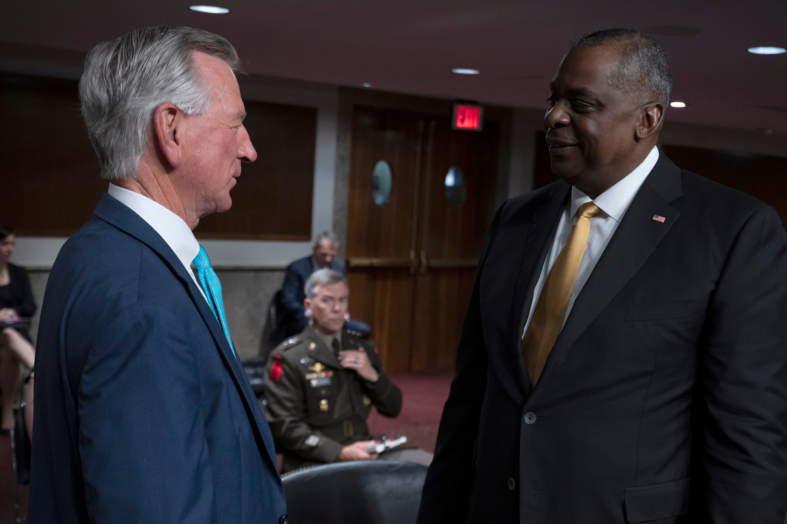 Secretary of Defense Lloyd J. Austin III speaks with Senator Tommy Tuberville of Alabama prior to appearing the Senate Armed Services Committee during the Department of Defense budget posture in review of the Defense Authorization Request for Fiscal Year 2022.