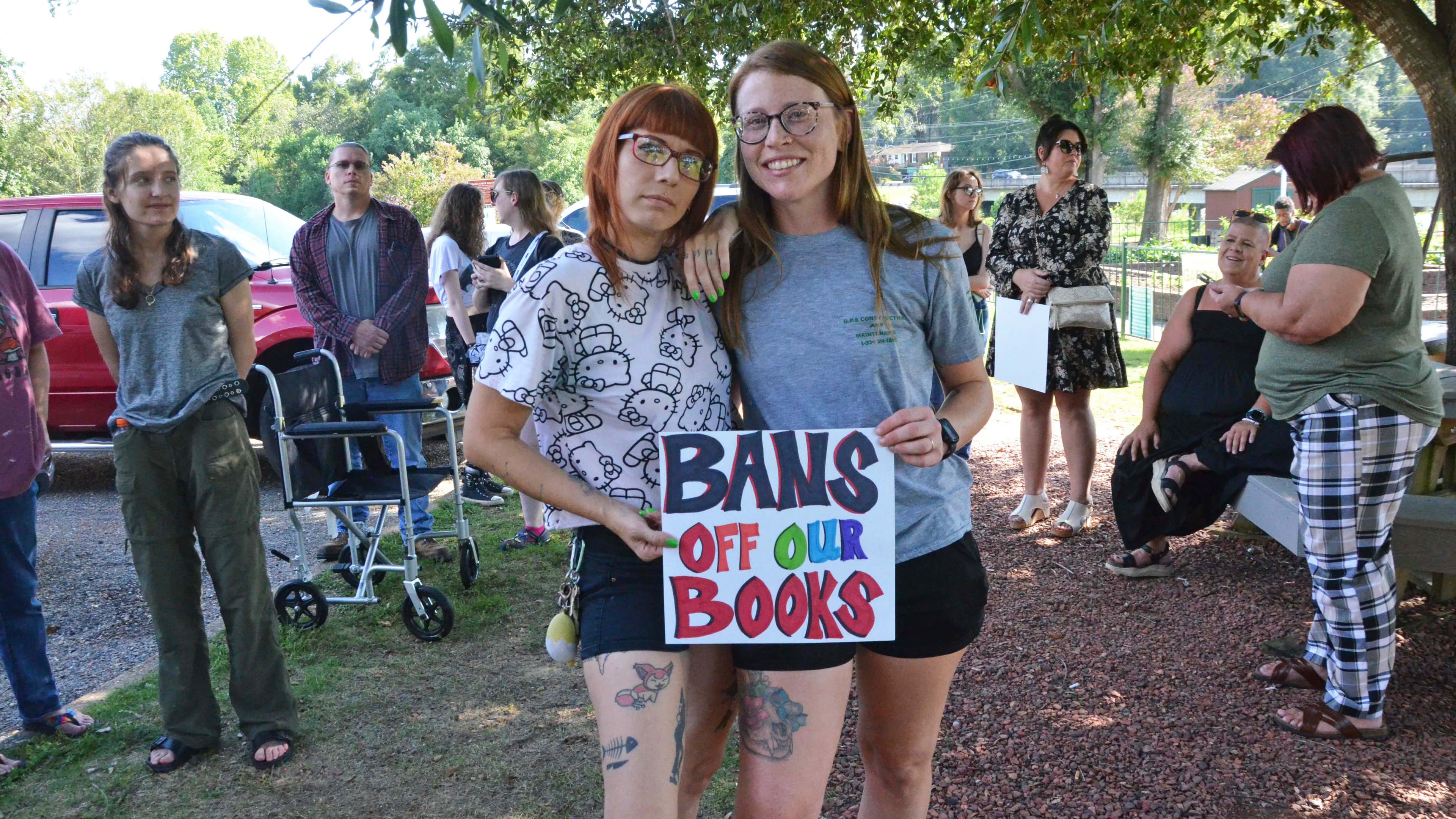 Madison Donahue and Krystle Suzanne show their support for the Autauga-Prattville Public Library on Tuesday ahead of a historic vote by the city council. (Madi Holmes/APR)