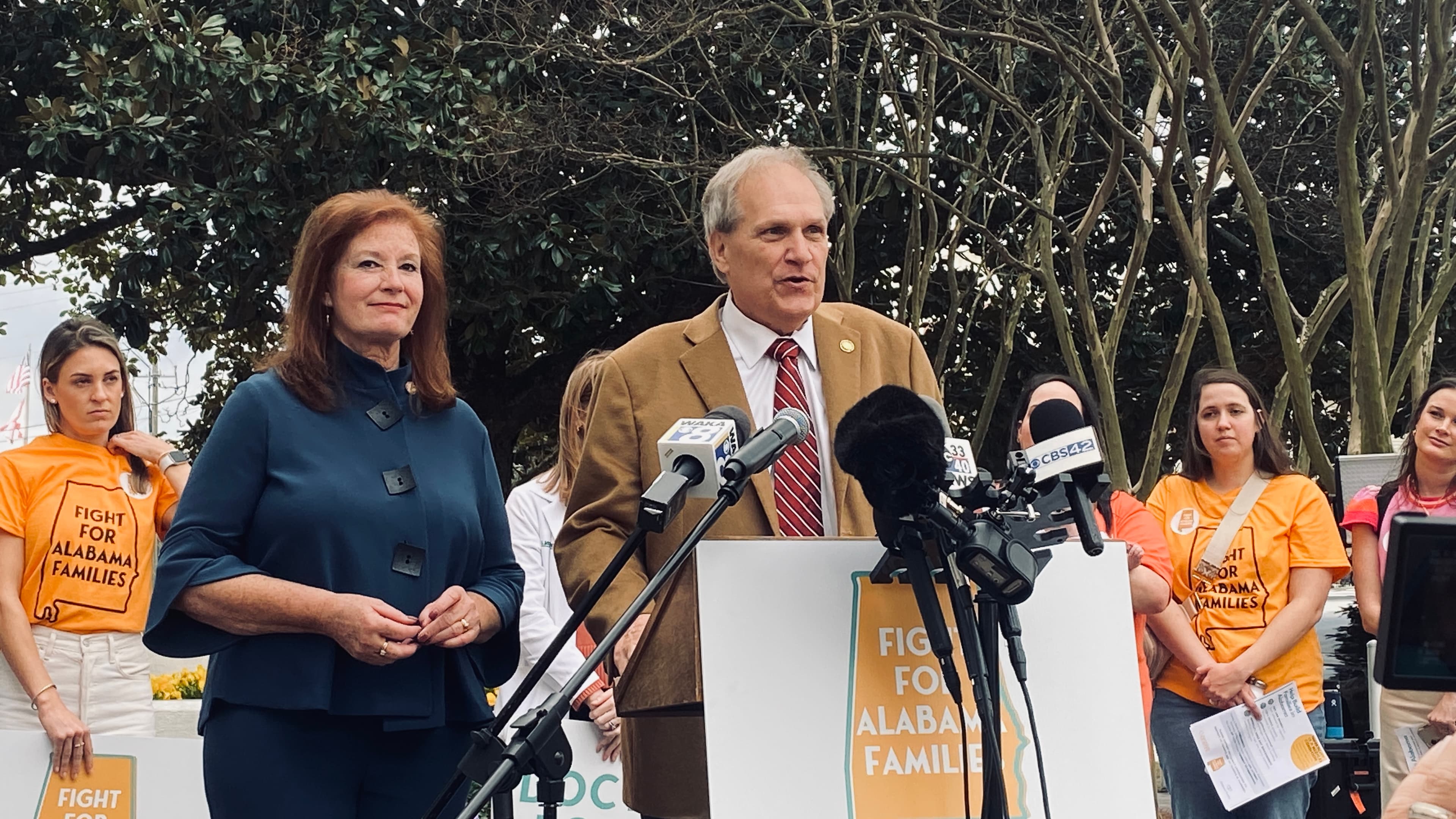 Sen. Tim Melson, R-Florence, and Rep. Terri Collins, R-Decatur, speak with advocates for IVF treatment outside the Alabama Statehouse on Wednesday, Feb. 28, 2024. (Jacob Holmes/APR)