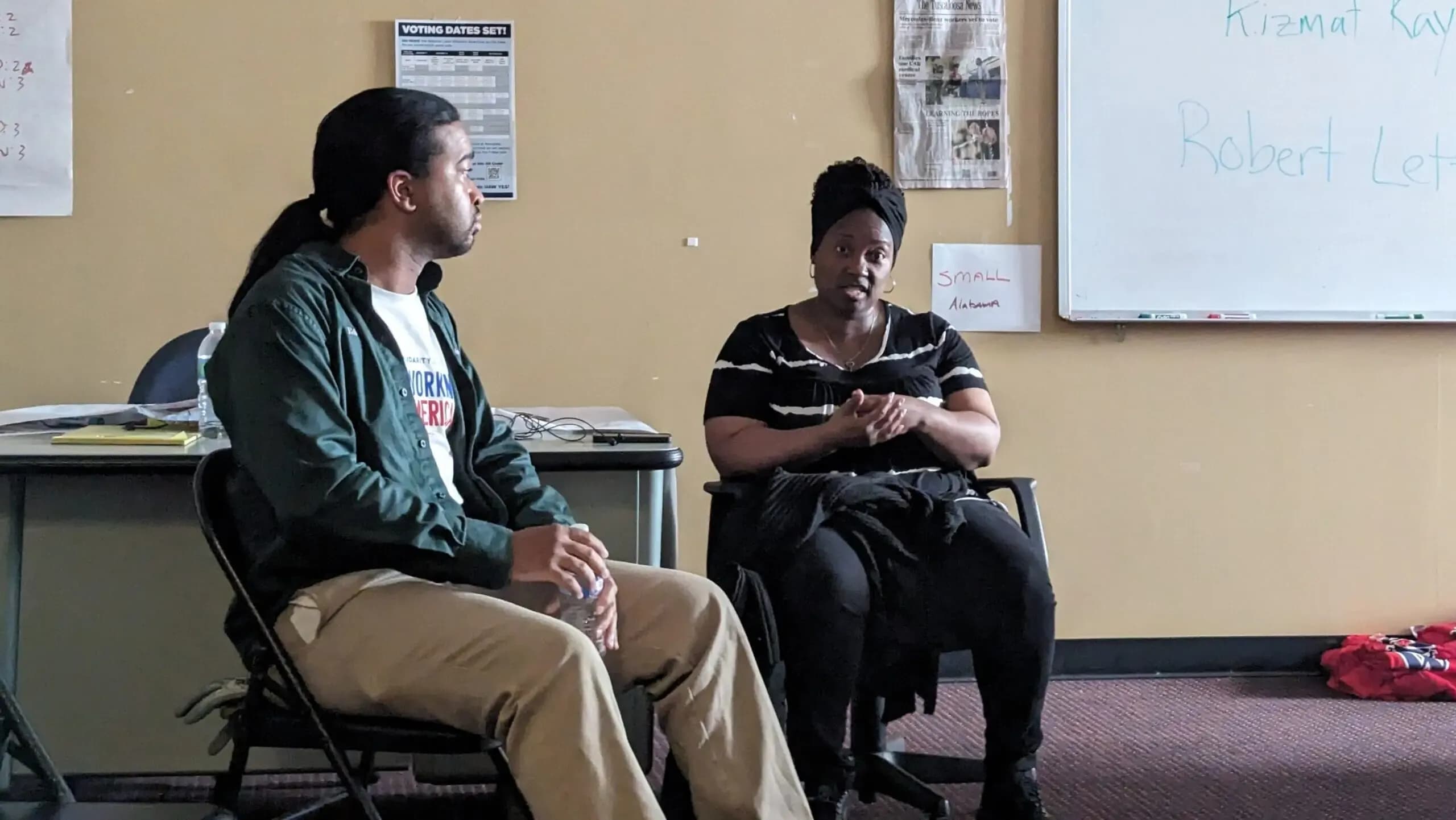 Mercedes workers Robert Lett (left) and Kay Finklea (right) talking with reporters at the UAW Local 112 headquarters in Coaling.
