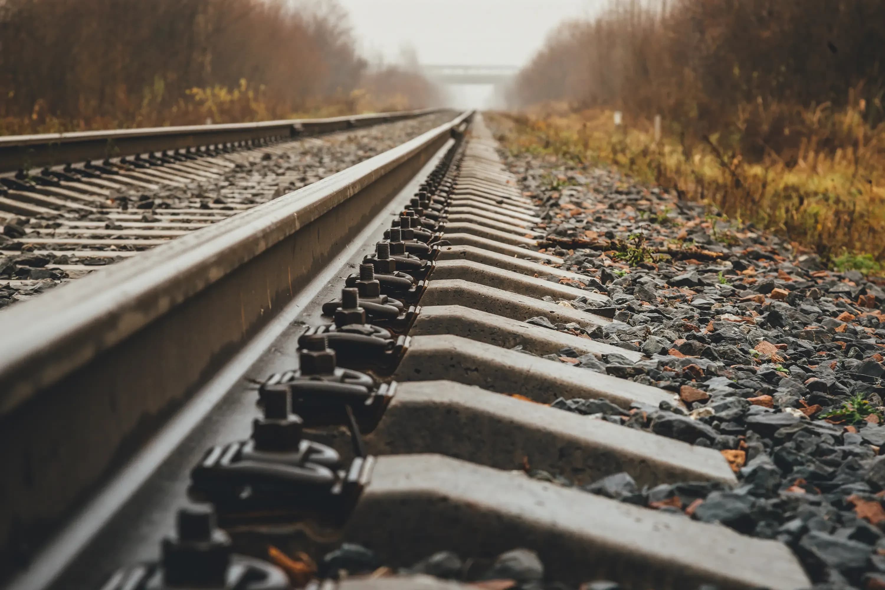 modern railway goes into foggy distance