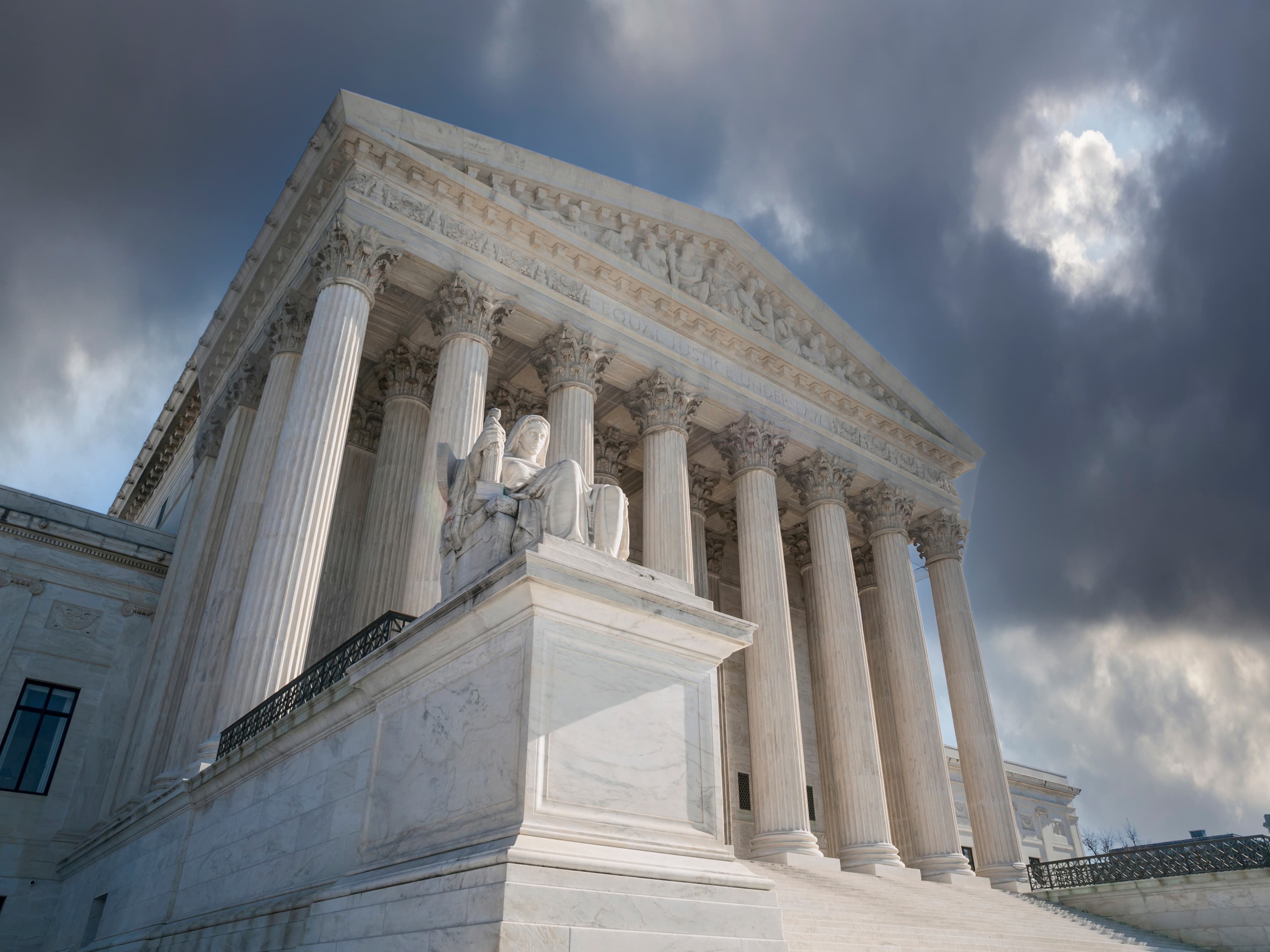 United States Supreme Court Building with stormy sky in Washington DC.
