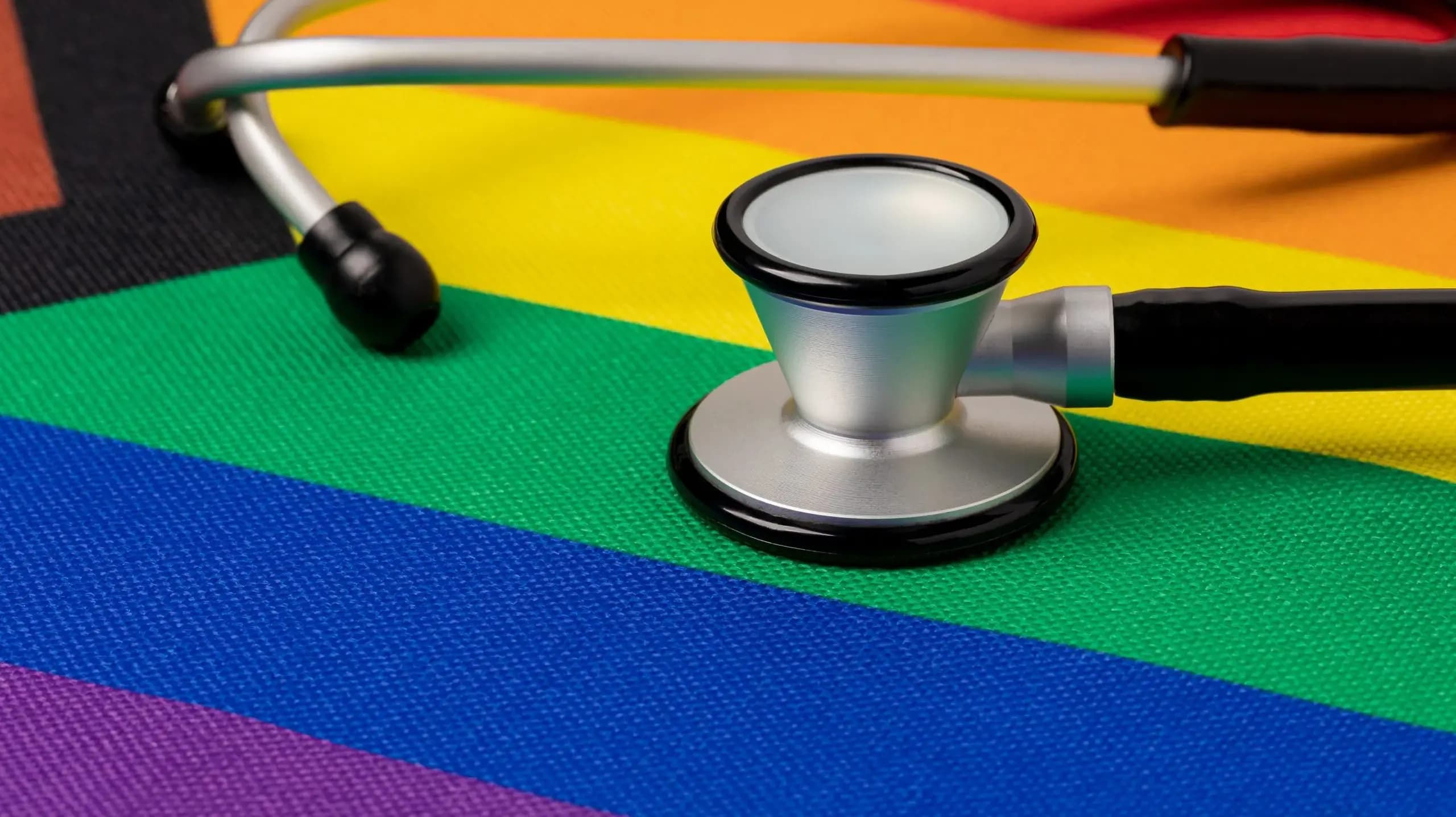 Rainbow pride flag and stethoscope. Transgender and LGBTQ+ healt