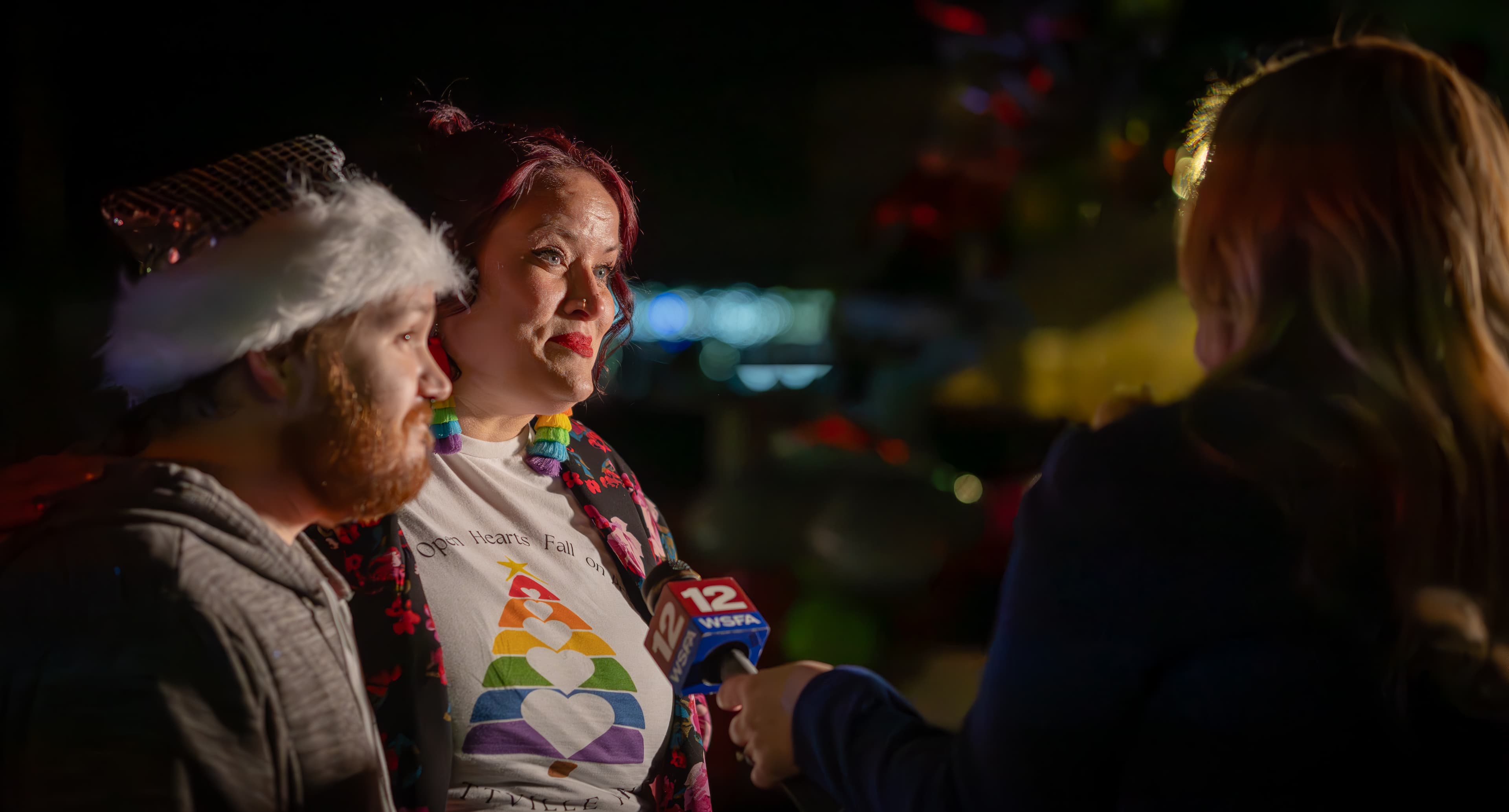 Prattville Pride president Adam Hunt and vice president Caryl Lawson speak with reporters before participating in the annual Prattville Christmas parade. (Wesleigh John/PRATTVILLE PRIDE)
