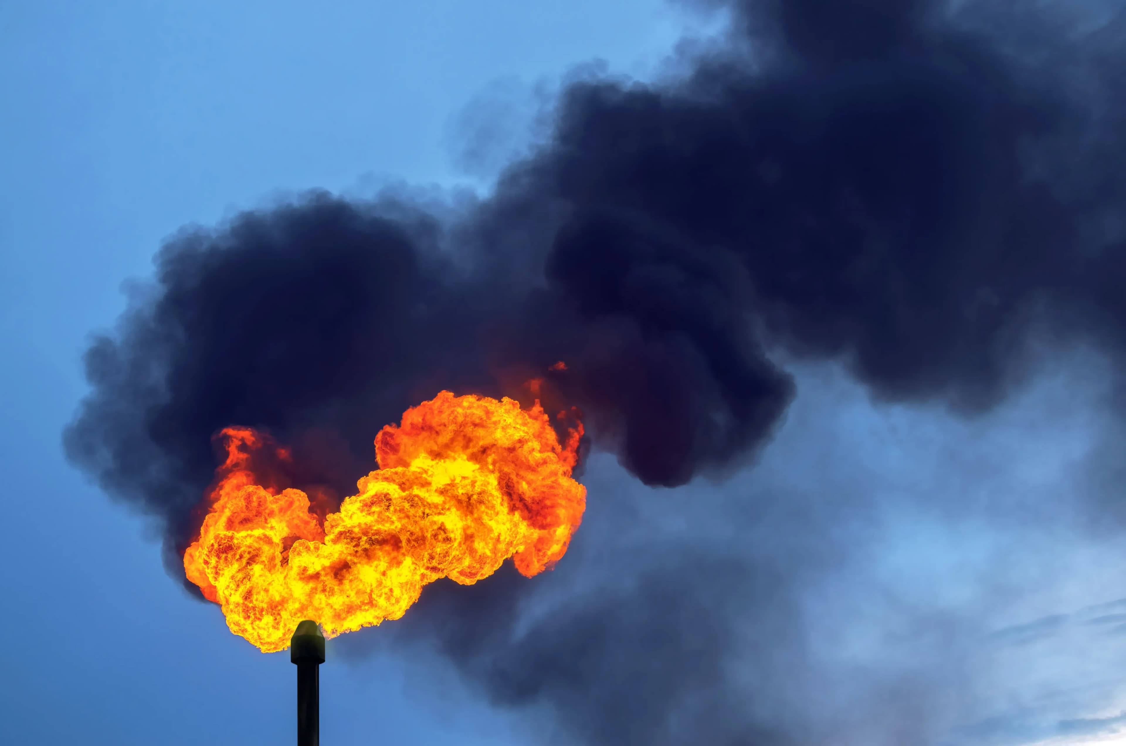Black smoke from burning of associated gas