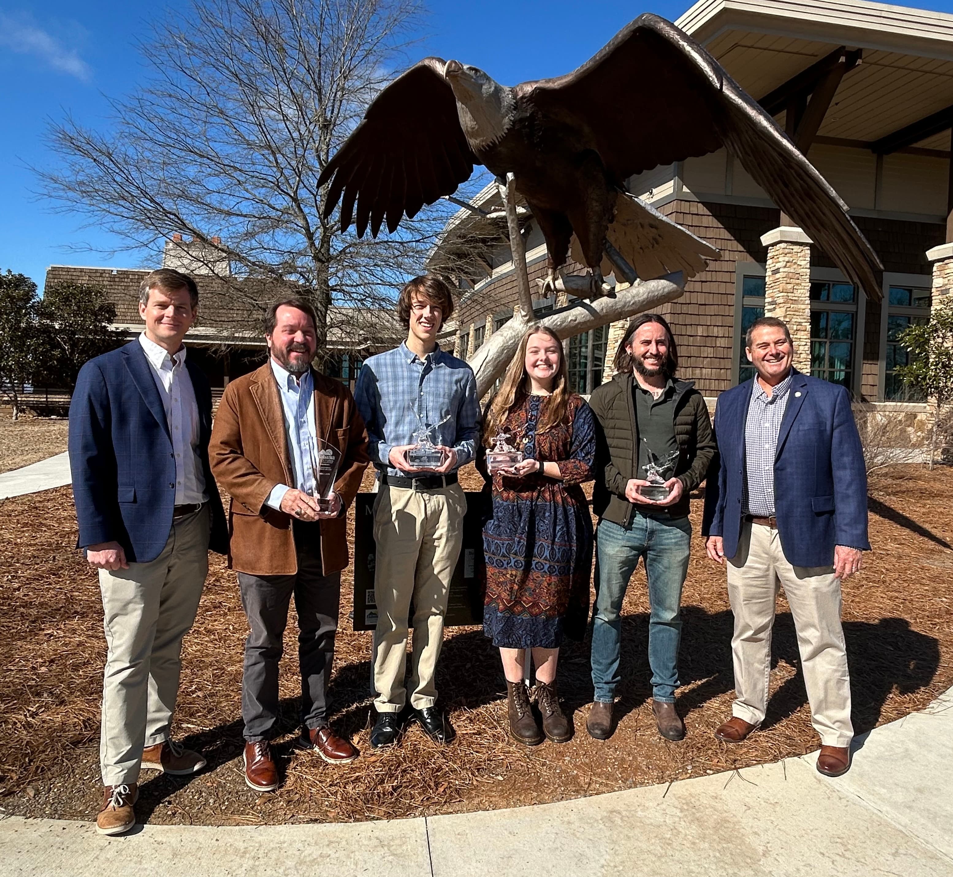 Alabama State Parks Director Matthew Capps (far left) and ADCNR Commissioner Chris Blankenship (far right) are pictured with Eagle Award winners who attended the awards ceremony Feb. 1, 2025, at Lake Guntersville State Park.