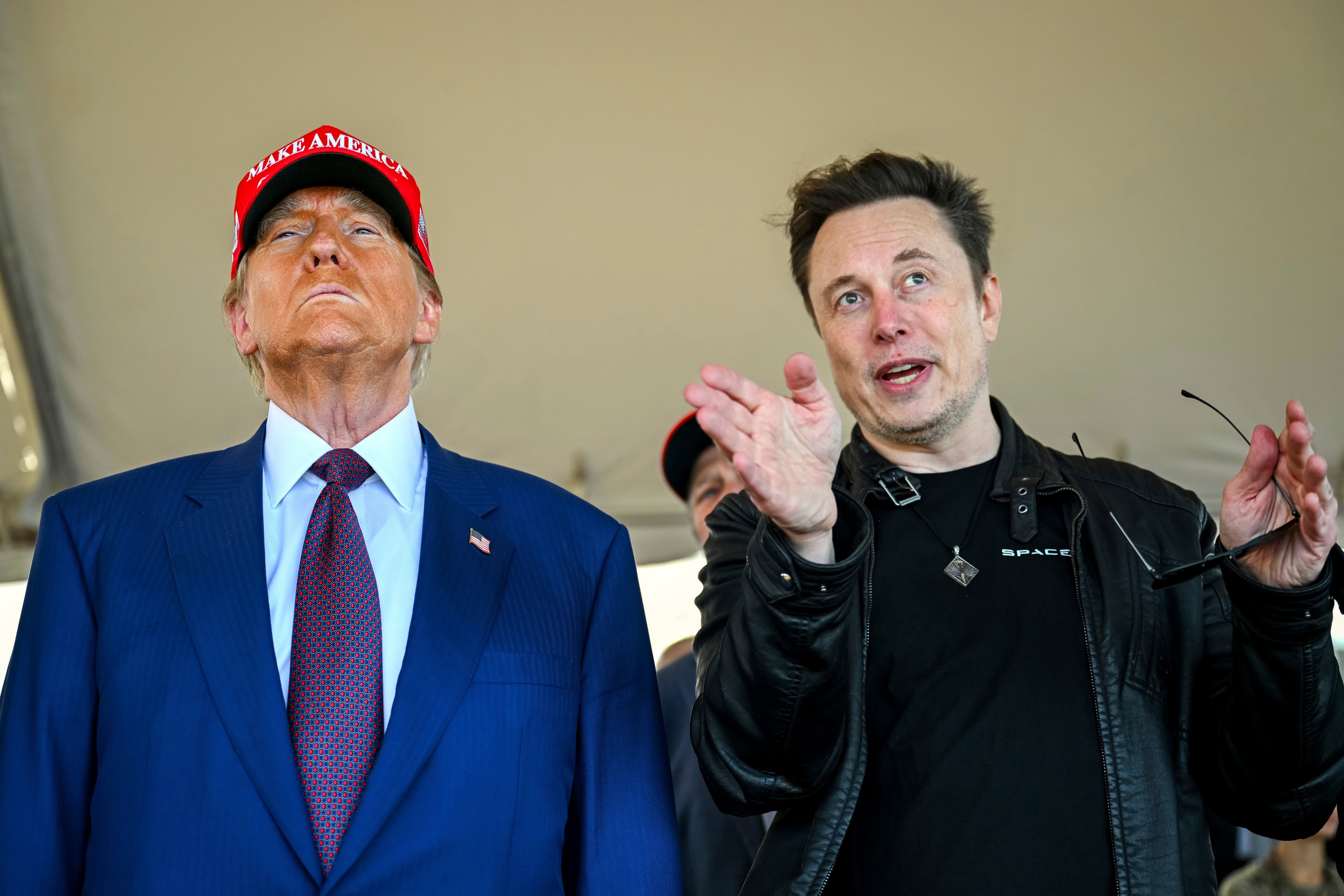 President-elect Donald Trump listens to Elon Musk as he arrives to watch SpaceX's mega rocket Starship lift off for a test flight from Starbase in Boca Chica, Texas, Nov. 19, 2024.