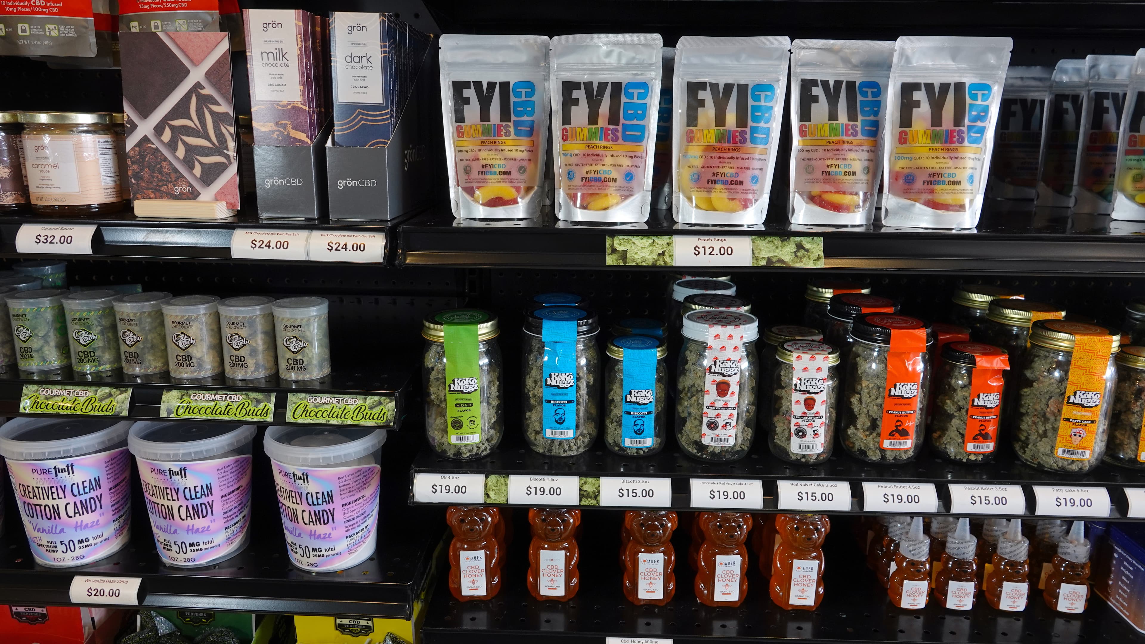 Various CBD infused edible products on a shelf inside retail store.