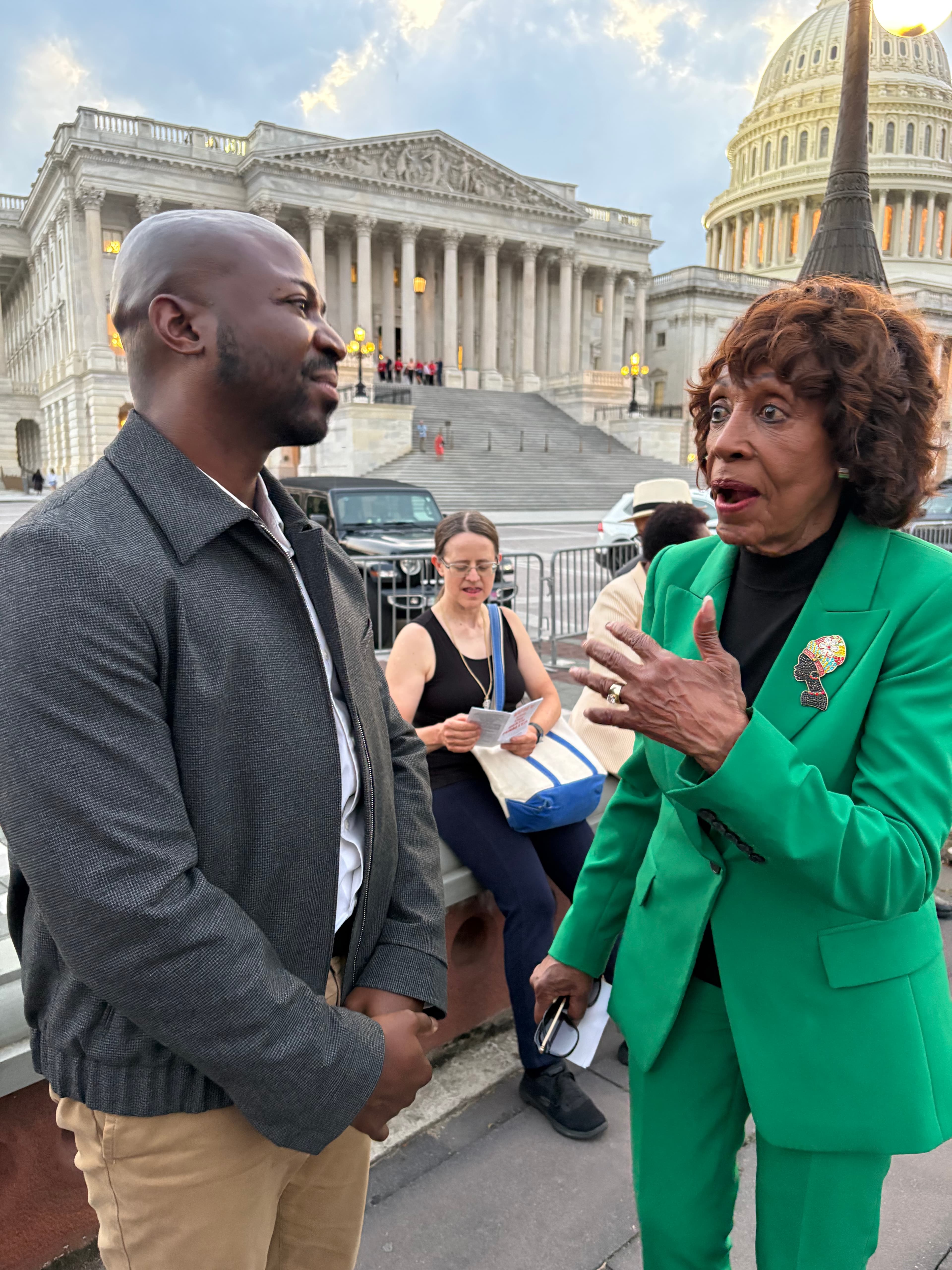 Dakarai Larriett speaks with U.S. Rep. Maxine Waters, D-CA, outside the U.S. Capitol in Washington, D.C.