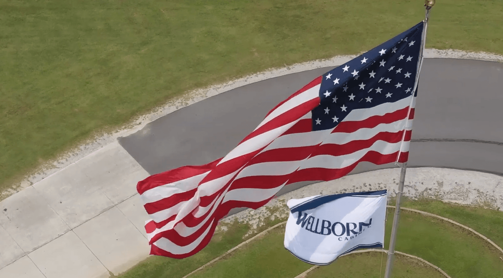 The U.S. flag flies above Wellborn Cabinet—just as American as the work inside.