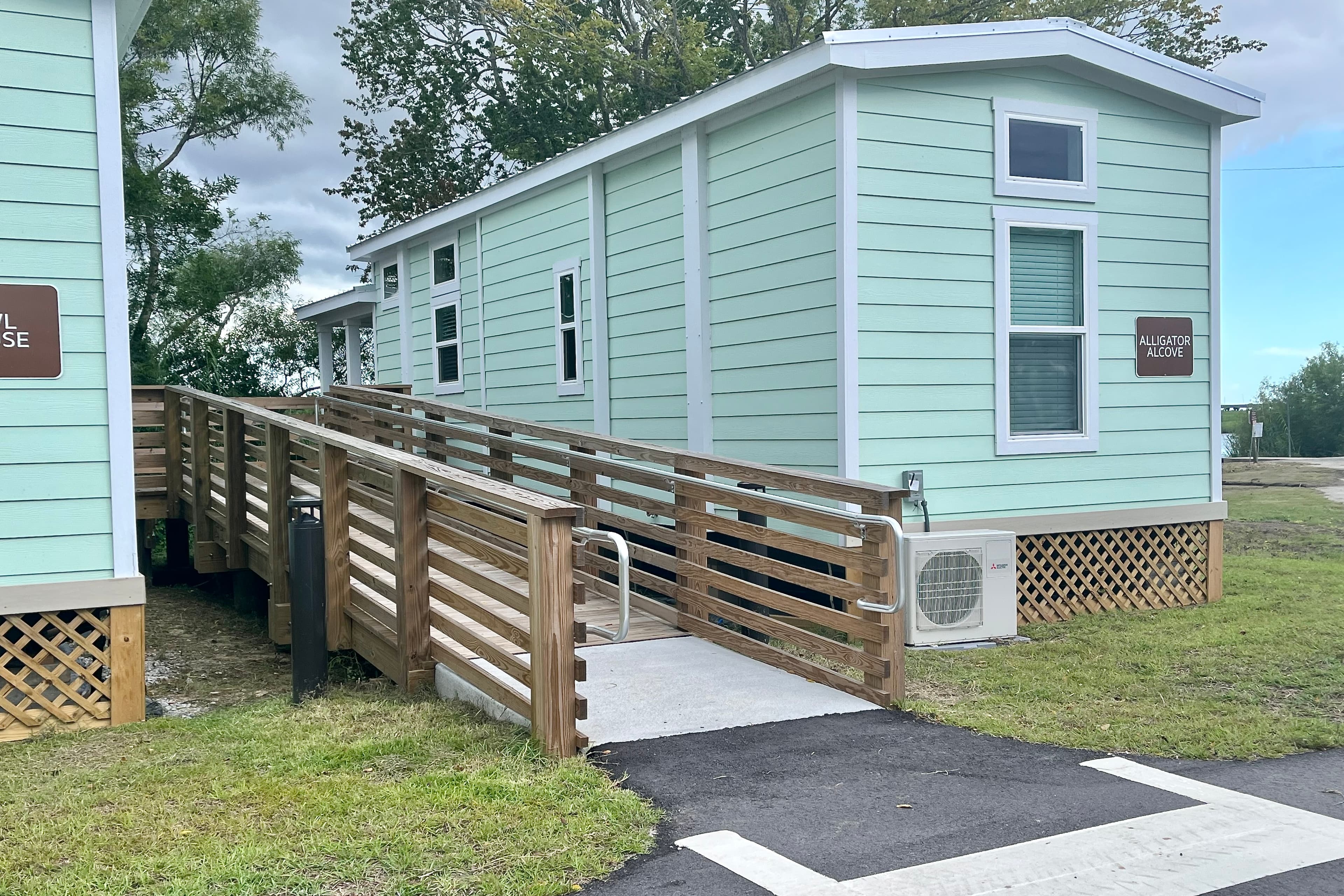 Officials gathered at Meaher State Park in Spanish Fort on Friday, Aug. 15, 2025 to celebrate significant upgrades at the park, including expansion of the campground, construction of a new park headquarters and bathhouse, and installation of four new tiny cabins, including this one, Alligator Alcove.