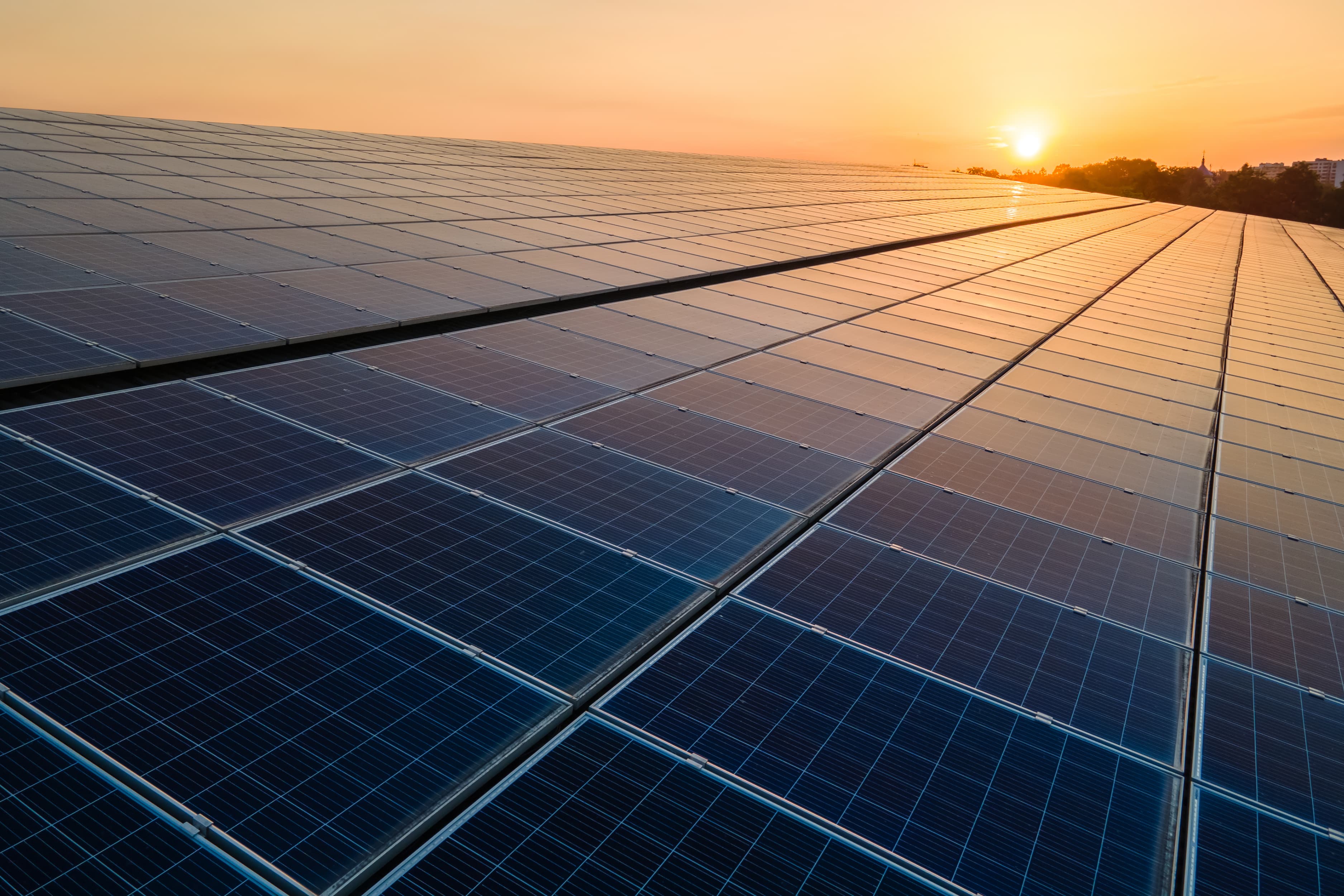 Blue photovoltaic solar panels mounted on building roof for prod