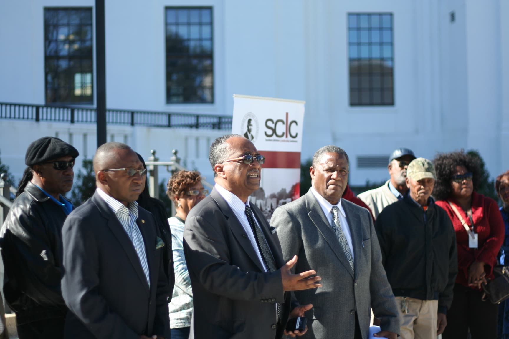 Sen. Bobby Singleton, D-Greensboro; Dr. Charles Steele and GreeneTrack CEO Luther Wynn speak on the steps of the Attorney General's office in Montgomery, Ala.