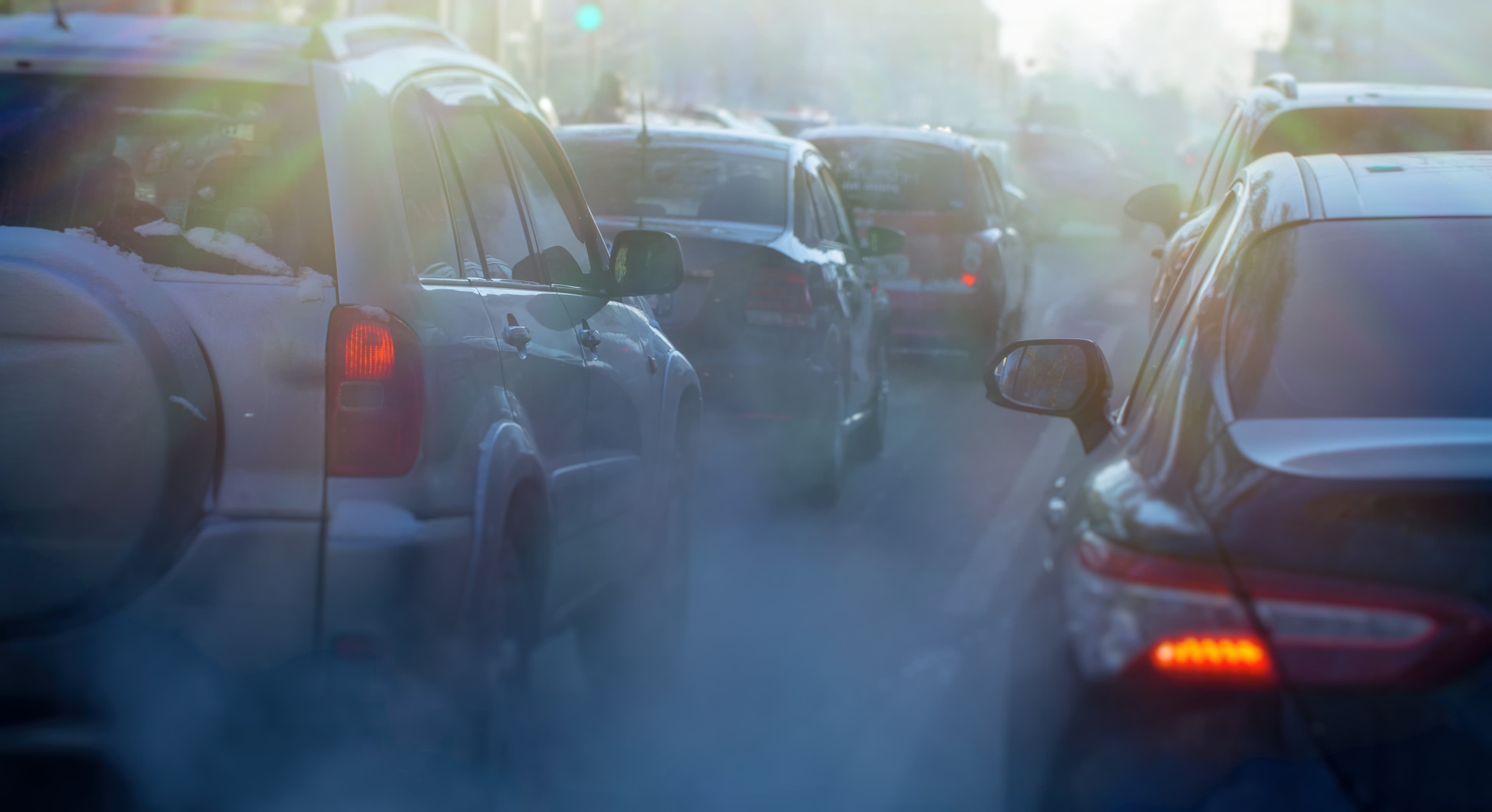 pollution from the exhaust of cars in the city in the winter. Smoke from cars on a cold winter day