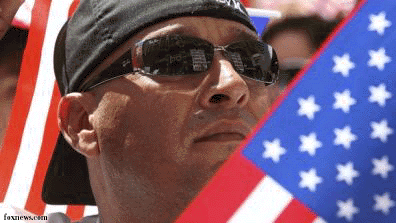 immigrant_carrying_flag_050110