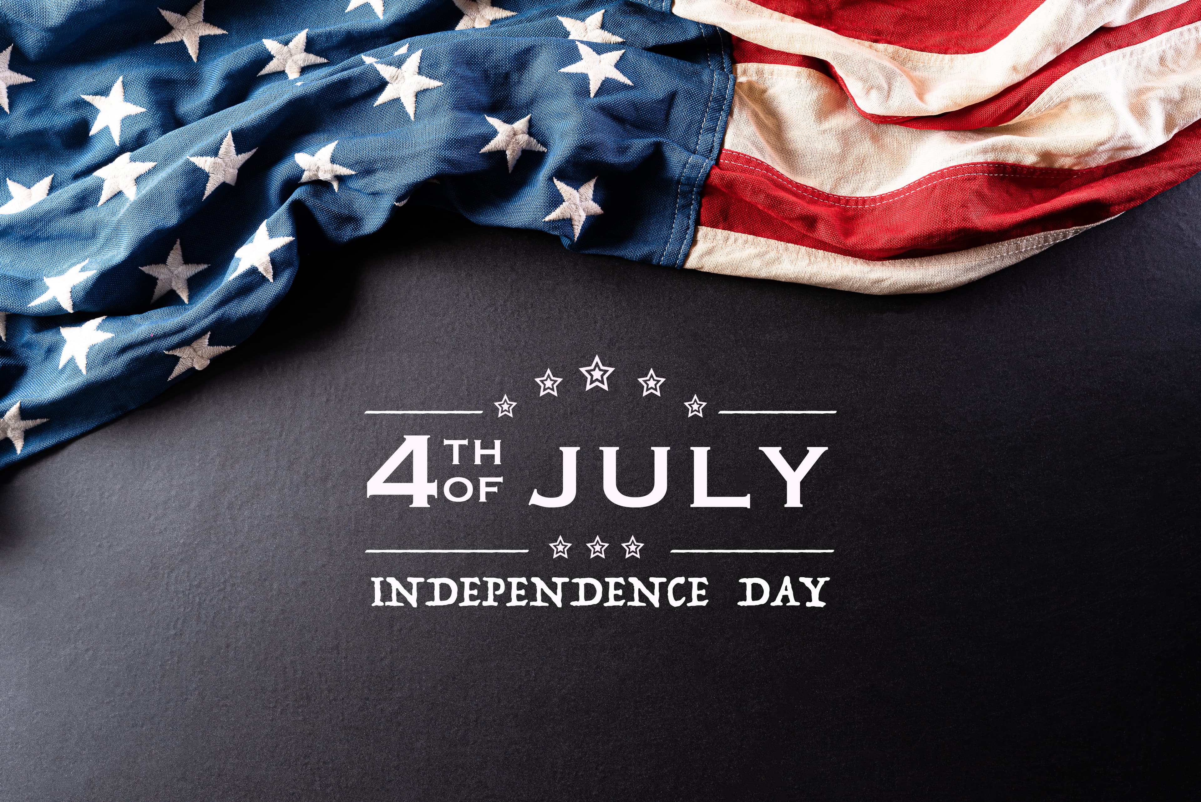 Happy Independence Day. American flags against a black background. July 4.